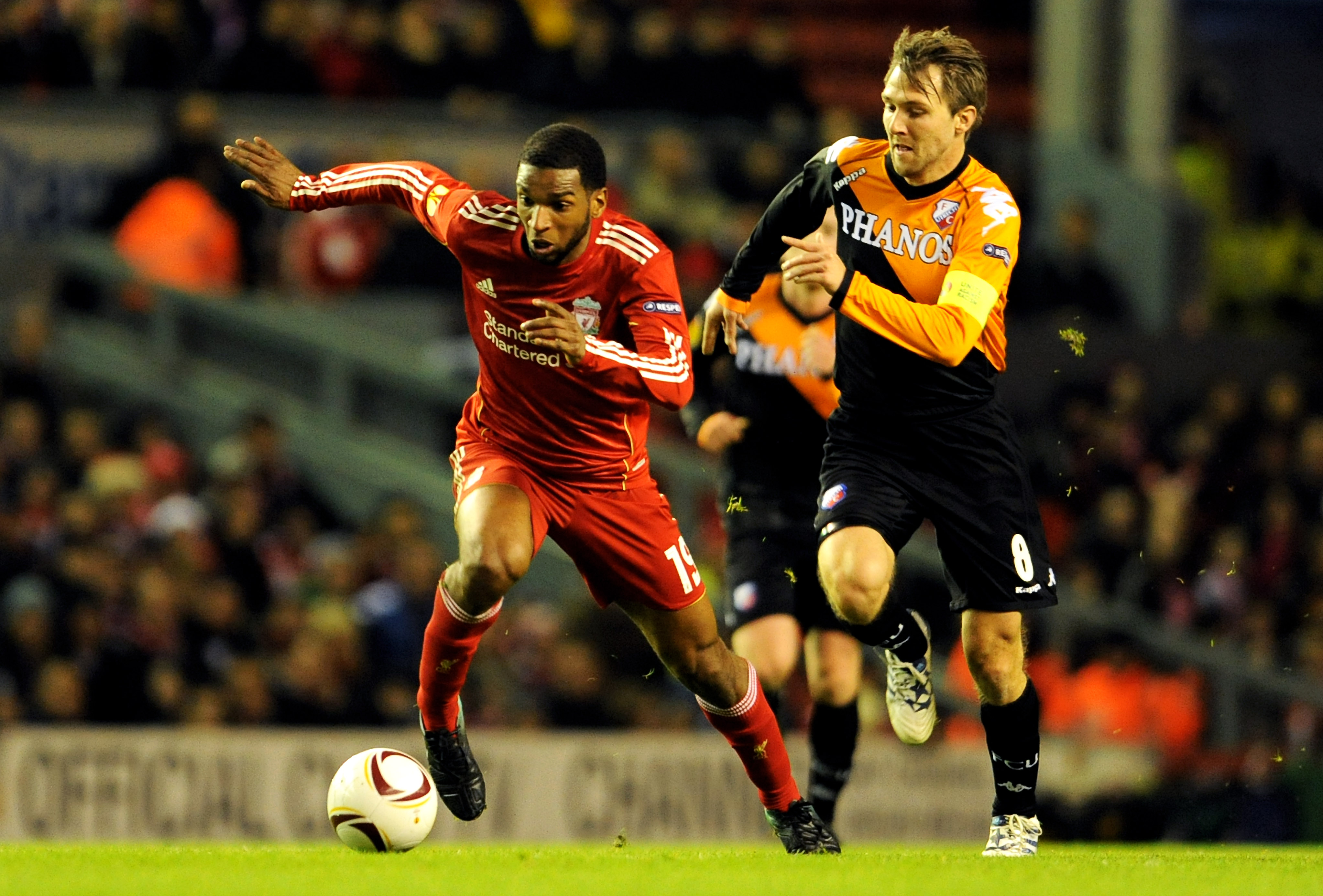 LIVERPOOL, ENGLAND - DECEMBER 15:  Ryan Babel of Liverpool is pursued by Michael Silberbauer of FC Utrecht during the UEFA Europa League Group K match between Liverpool and FC Utrecht at Anfield on December 15, 2010 in Liverpool, England.  (Photo by Clint