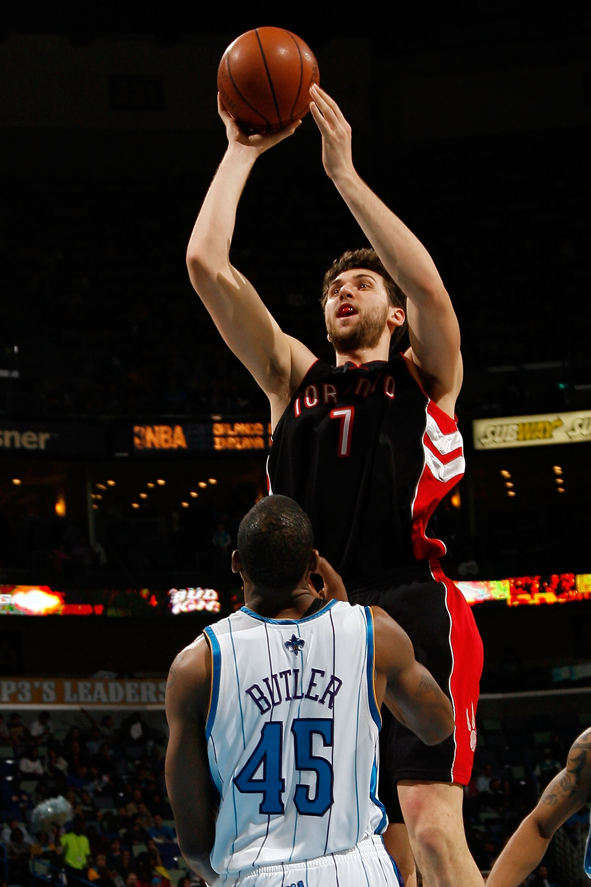 NEW ORLEANS - FEBRUARY 06:  Andrea Bargnani #7 of the Toronto Raptors makes a shot over Rasual Butler #45 of the New Orleans Hornets on February 6, 2009 in New Orleans, Louisiana. The Hornets defeated the Raptors 101-92.   NOTE TO USER: User expressly ack