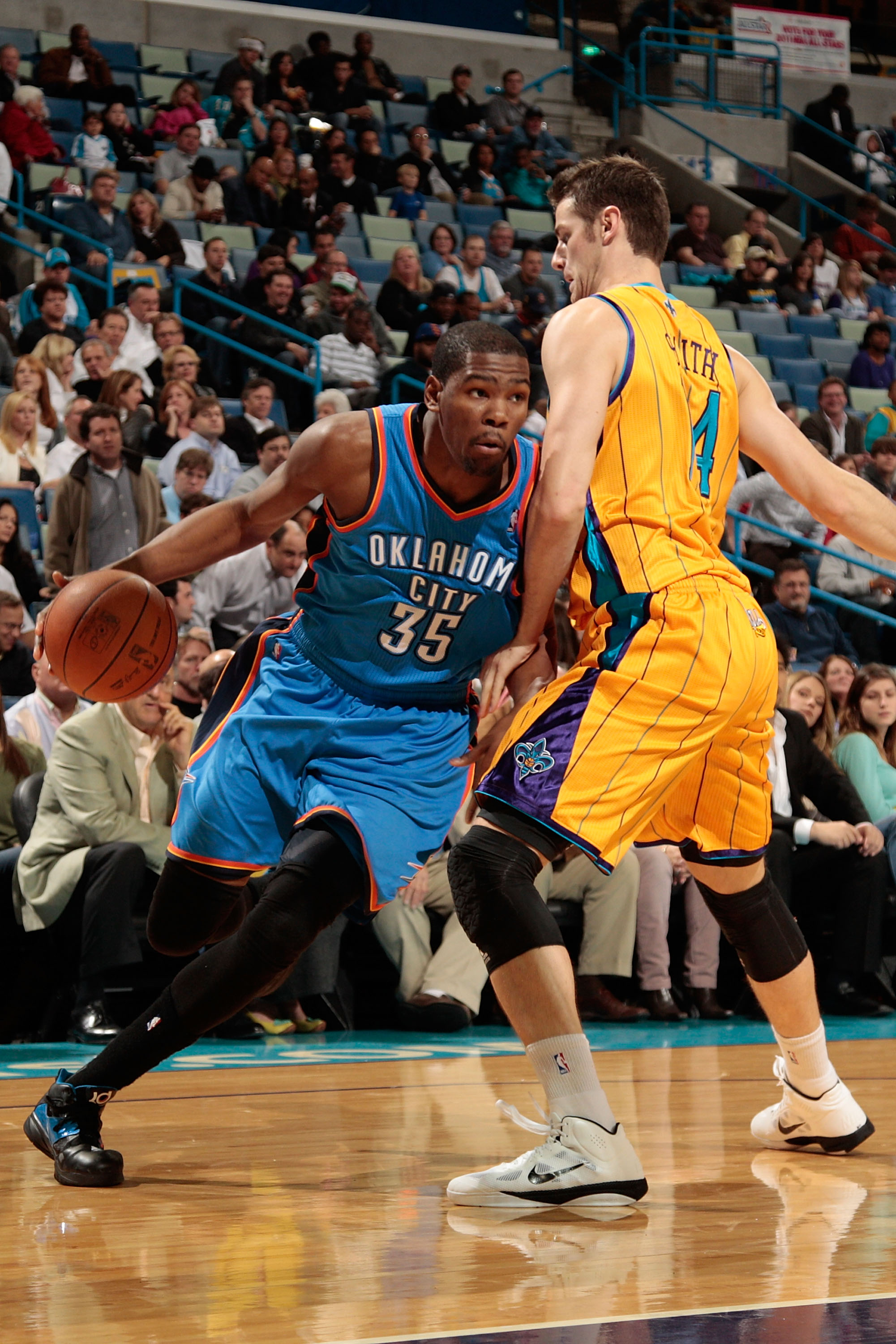NEW ORLEANS, LA - DECEMBER 10:  Kevin Durant #35 of the Oklahoma City Thunder drives the ball around Jason Smith #14 of the New Orleans Hornets  at New Orleans Arena on December 10, 2010 in New Orleans, Louisiana.    The Thunder defeated the Hornets 97-92