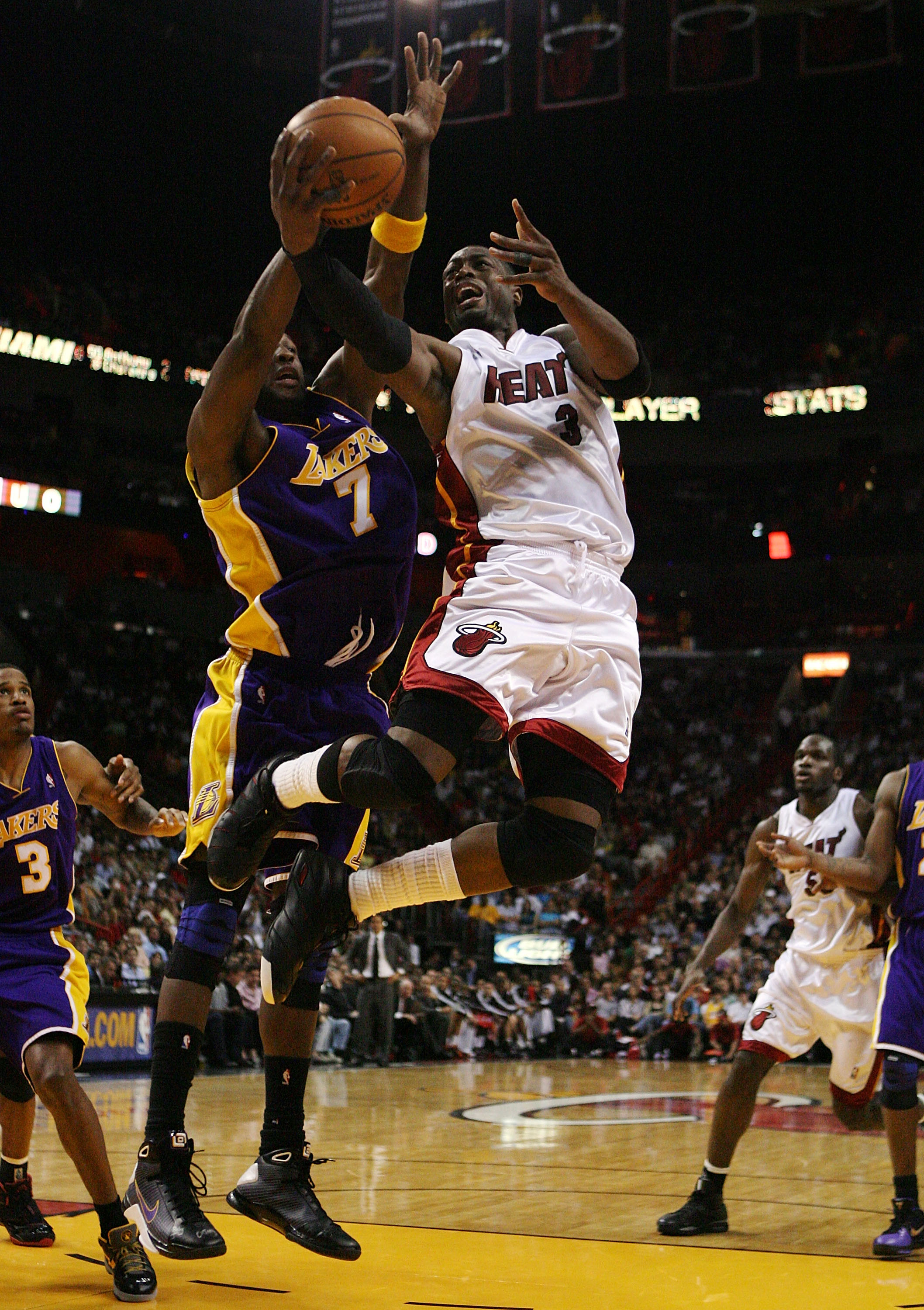 MIAMI - DECEMBER 19:  Dwyane Wade #3 of the Miami Heat scores over Lamar Odom #7 of the Los Angeles Lakers at American Airlines Arena on December 19, 2008 in Miami, Florida. The Heat defeated the Lakers 89-87. NOTE TO USER: User expressly acknowledges and