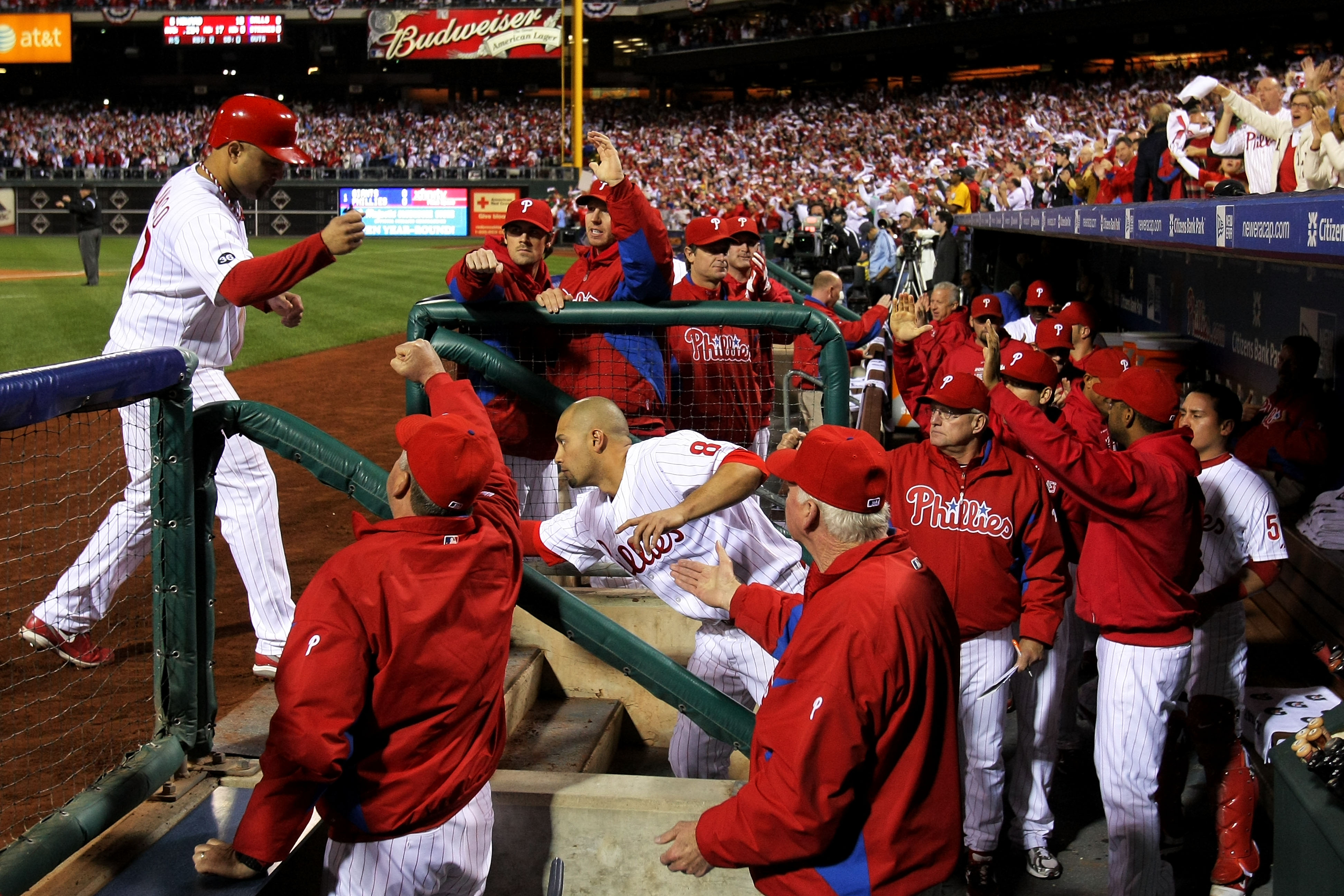 PHILADELPHIA - OCTOBER 23:  Placido Polanco #27 of the Philadelphia Phillies is congratulated by teammates after scoring on in the first inning against the San Francisco Giants in Game Six of the NLCS during the 2010 MLB Playoffs at Citizens Bank Park on