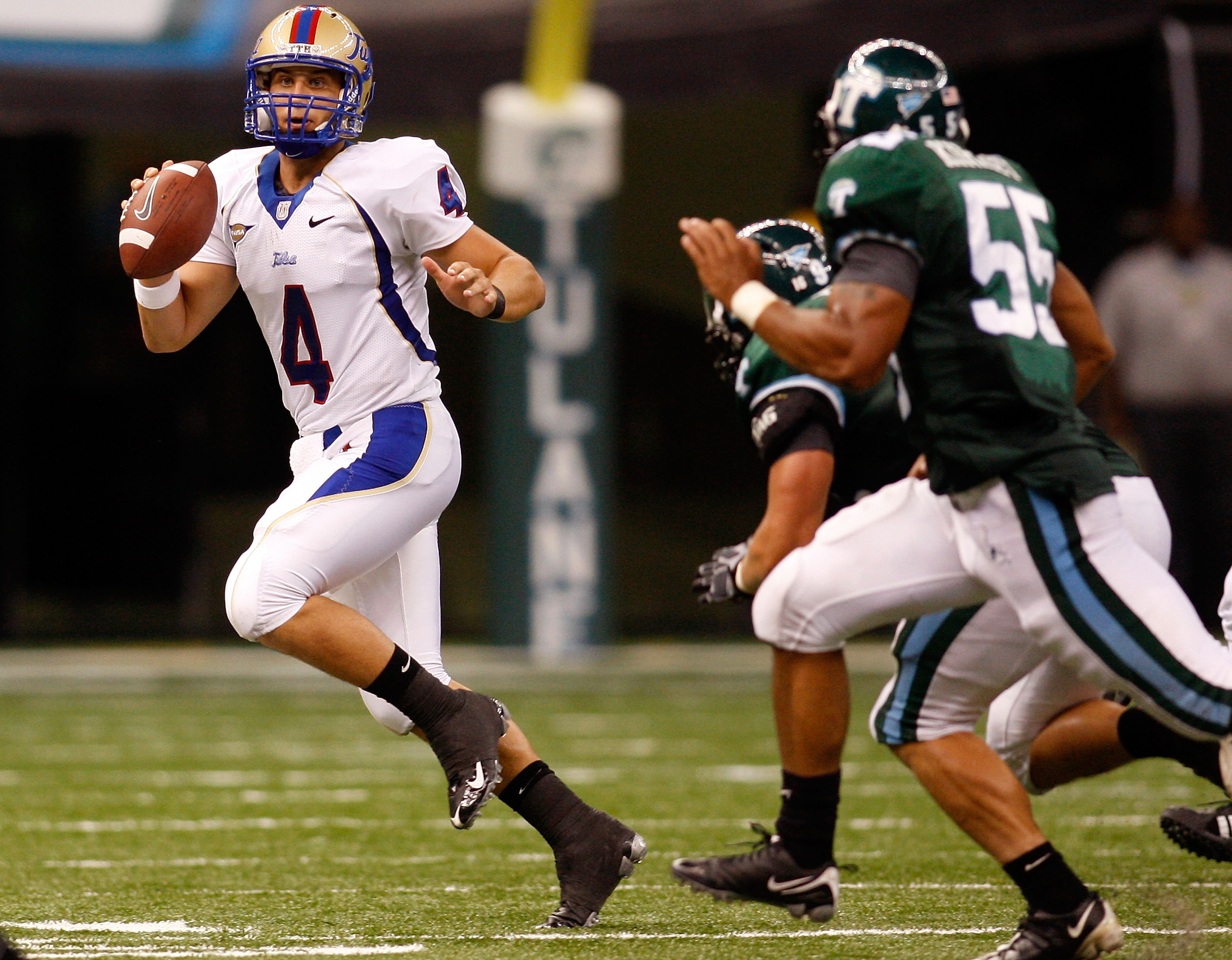 NEW ORLEANS - SEPTEMBER 04: Quarterback G.J. Kinne #4 of the Tulsa Golden Hurricanes scrambles with the football against the Tulane Green Wave at the Louisiana Superdome on September 4, 2009 in New Orleans, Louisiana. The Hurricanes defeated the Green