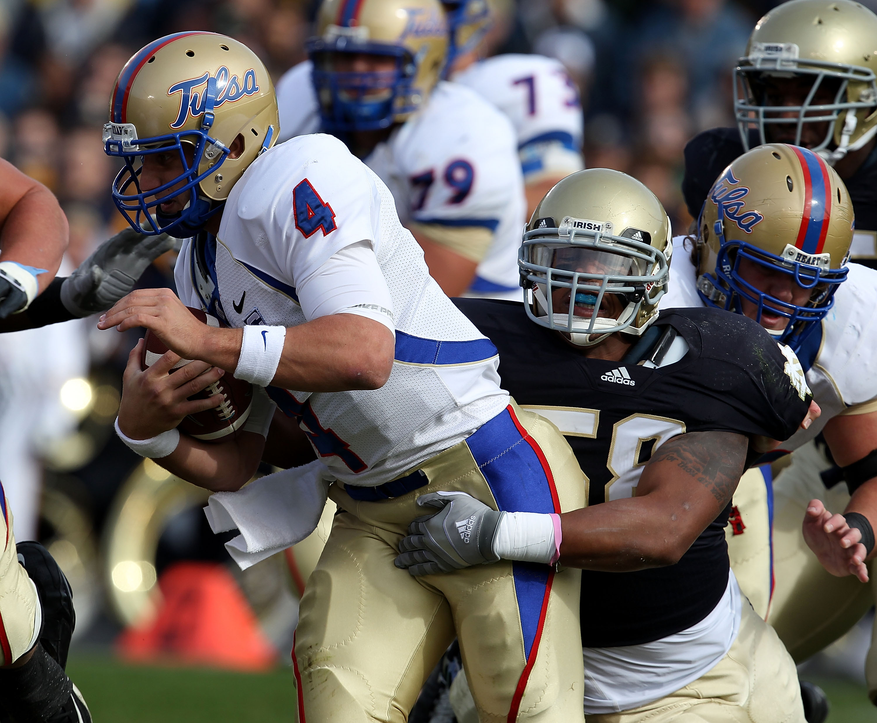 SOUTH BEND, IN - OCTOBER 30: Brian Smith #58 of the Notre Dame Fighting Irish sacks G.J. Kinne #4 of the Tulsa Golden Hurricane at Notre Dame Stadium on October 30, 2010 in South Bend, Indiana. (Photo by Jonathan Daniel/Getty Images)