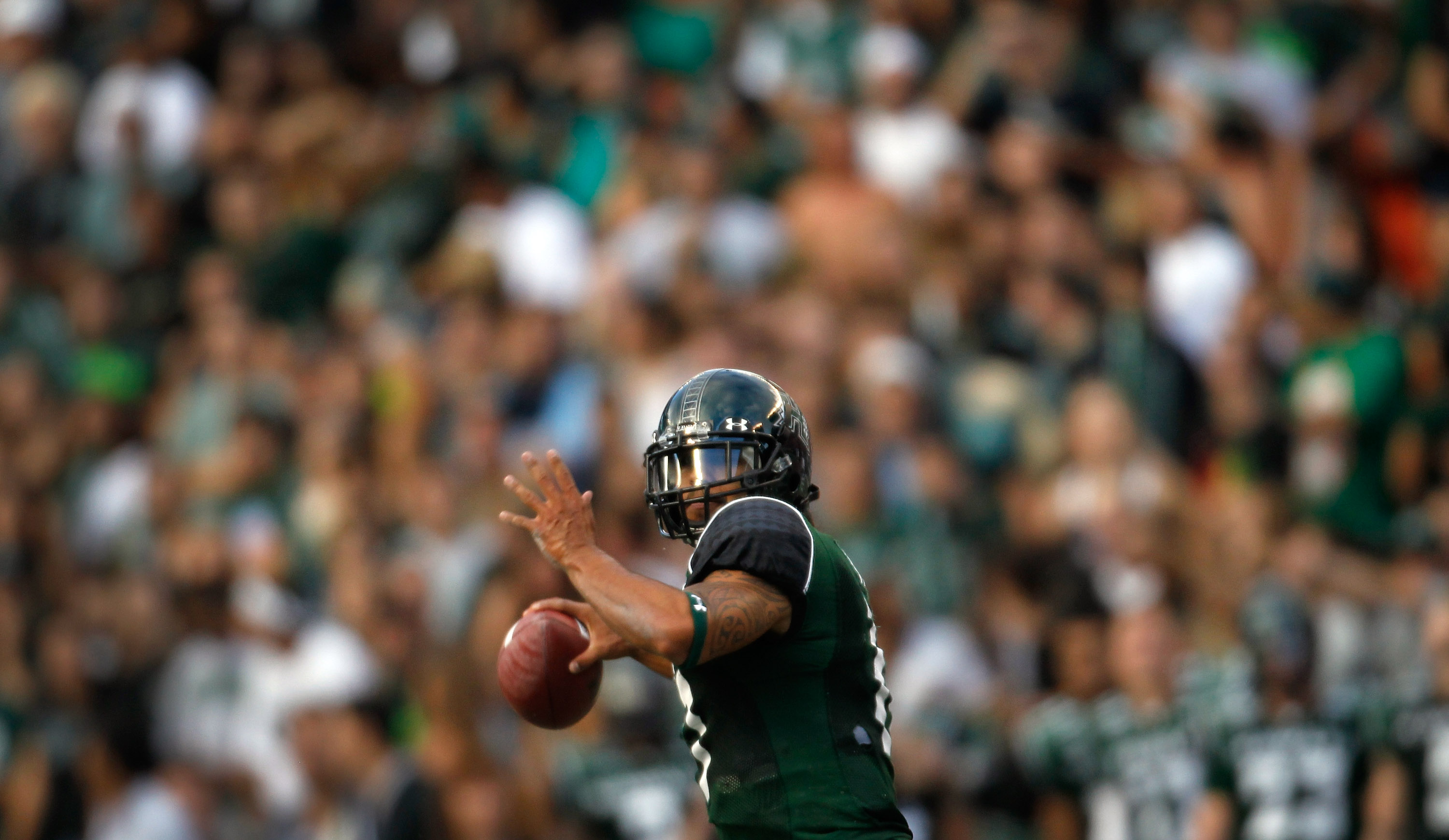 HONOLULU - SEPTEMBER 2: Quarterback Bryant Moniz #17 of the University of Hawaii Warriors makes a pass against the University of Southern California Trojans during first half action at Aloha Stadium September 2, 2010 in Honolulu, Hawaii. (Photo by Kent N