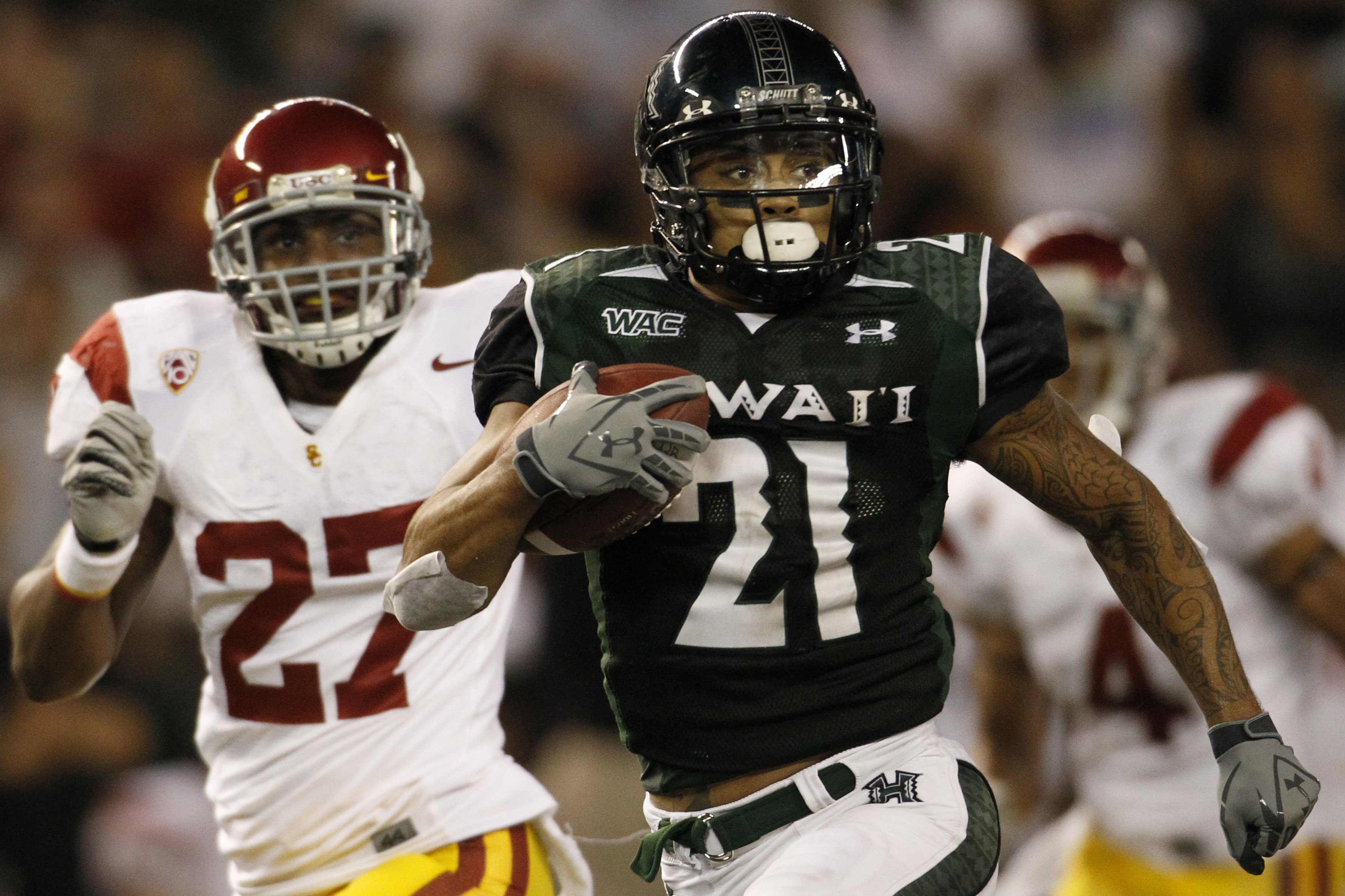 HONOLULU - SEPTEMBER 02: Kealoha Pilares #21 of the University of Hawaii Warriors carries the ball during second half action second half action at Aloha Stadium September 2, 2010 in Honolulu, Hawaii. (Photo by Kent Nishimura/Getty Images)