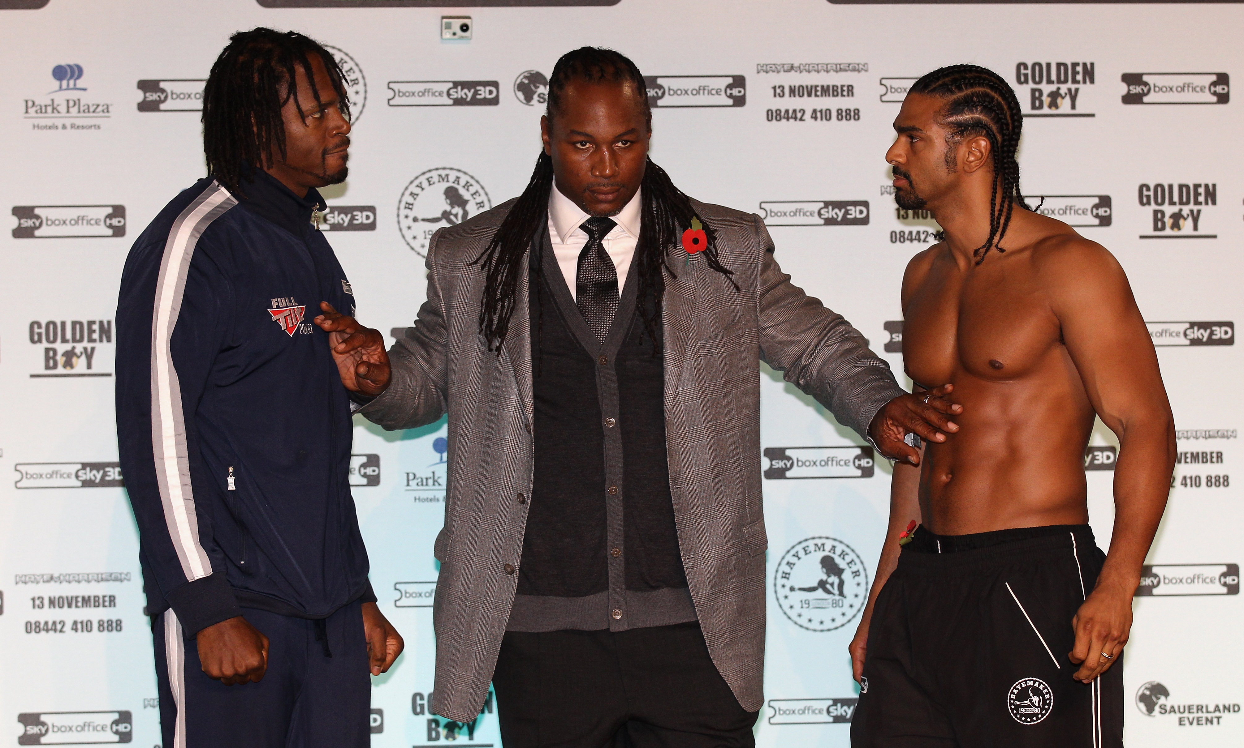 MANCHESTER, ENGLAND - NOVEMBER 12: Former heavyweight champion of the world, Lennox Lewis, steps in between David Haye and Audley Harrison as they go face to face during the official weigh-in at The Lowry Theatre on November 12, 2010 in Manchester, Engla