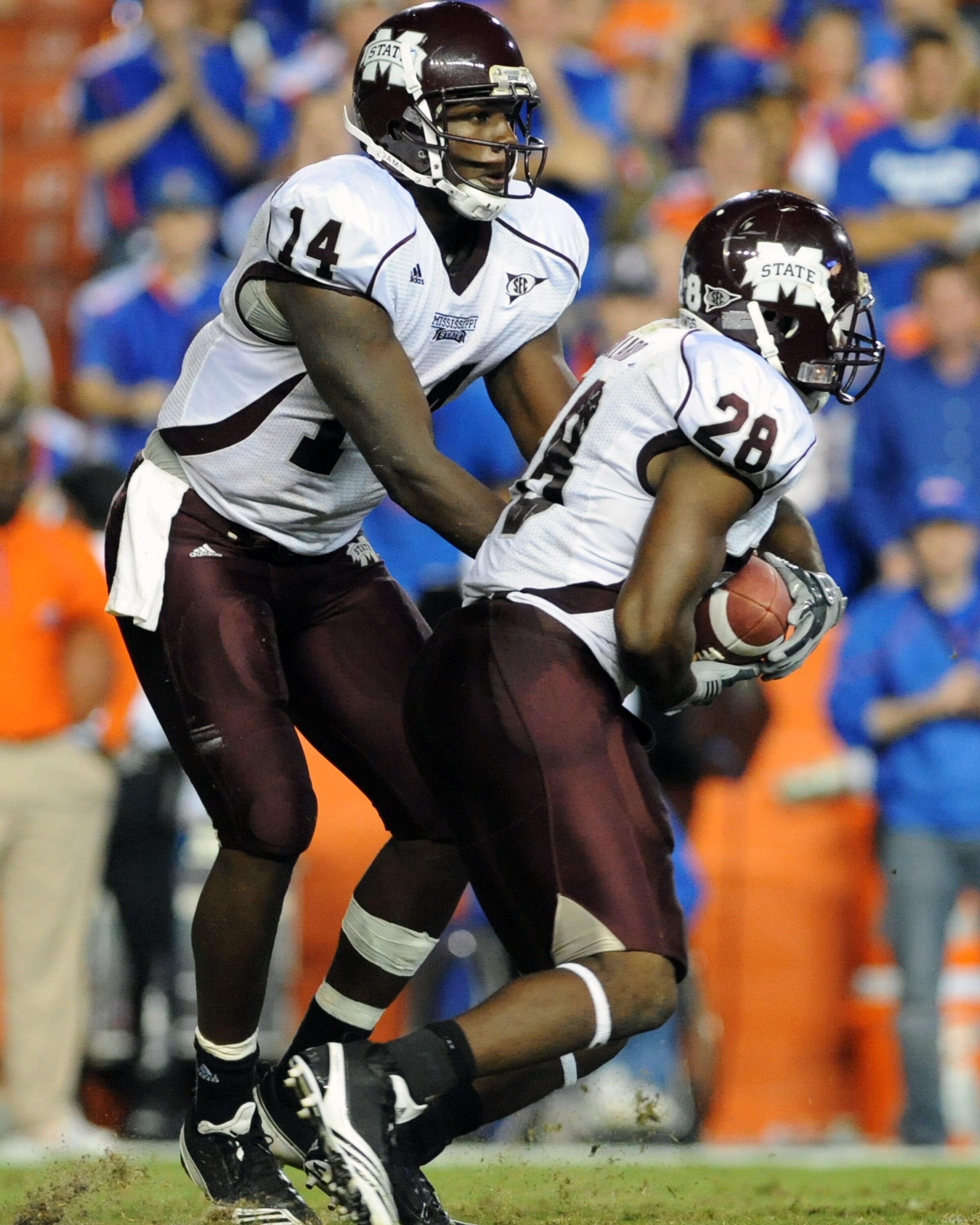 GAINESVILLE, FL - OCTOBER 16:  Quarterback Chris Relf #14 of the Mississippi State Bulldogs hands off to running back Vick Ballard #28  against the Florida Gators  October 16, 2010 Ben Hill Griffin Stadium at Gainesville, Florida.  (Photo by Al Messerschm