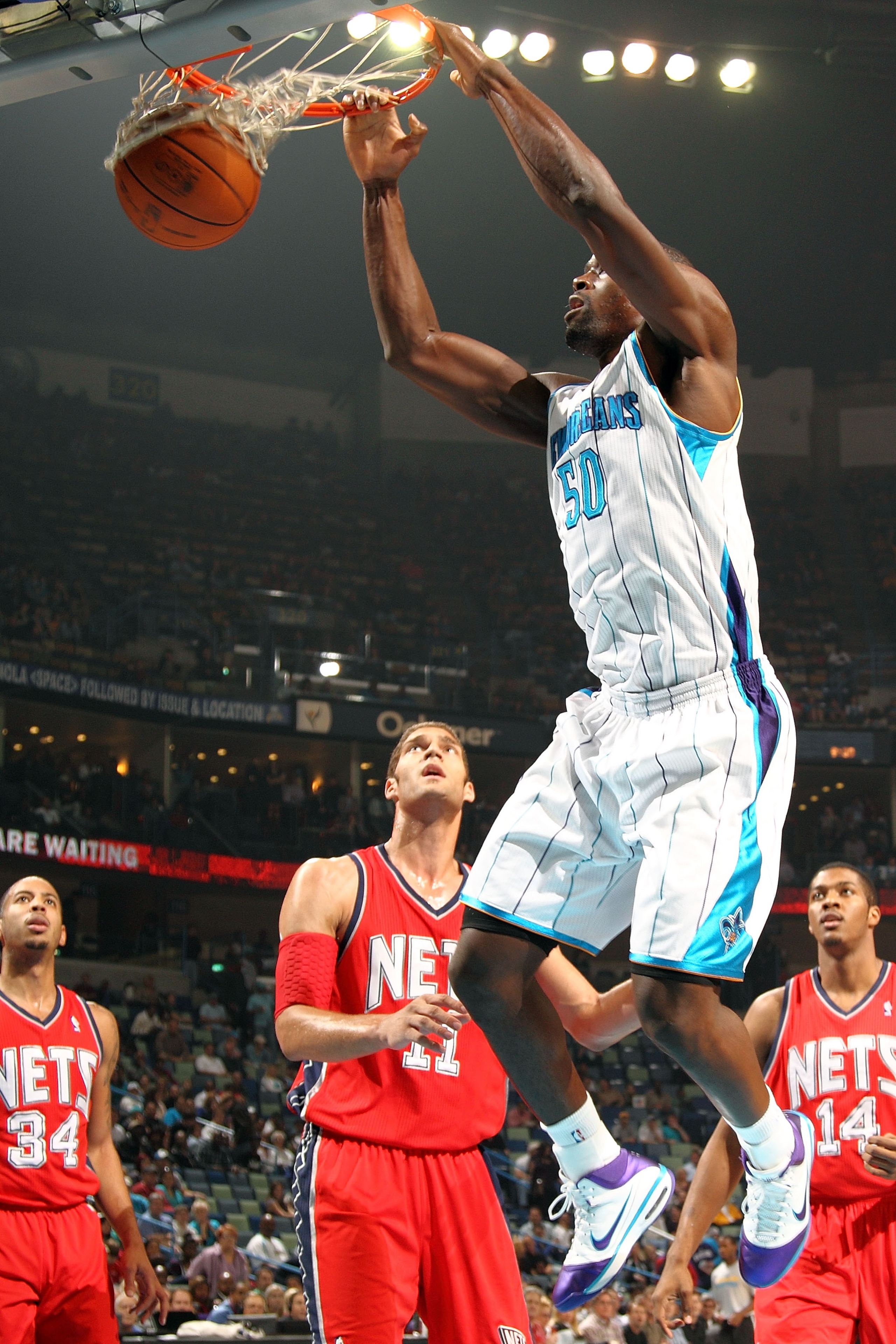 NEW ORLEANS, LA - DECEMBER 22:  Emeka Okafor #50 of the New Orleans Hornets dunks the ball over Brook Lopez #11 of the New Jersey Nets at the New Orleans Arena on December 22, 2010 in New Orleans, Louisiana.   NOTE TO USER: User expressly acknowledges and