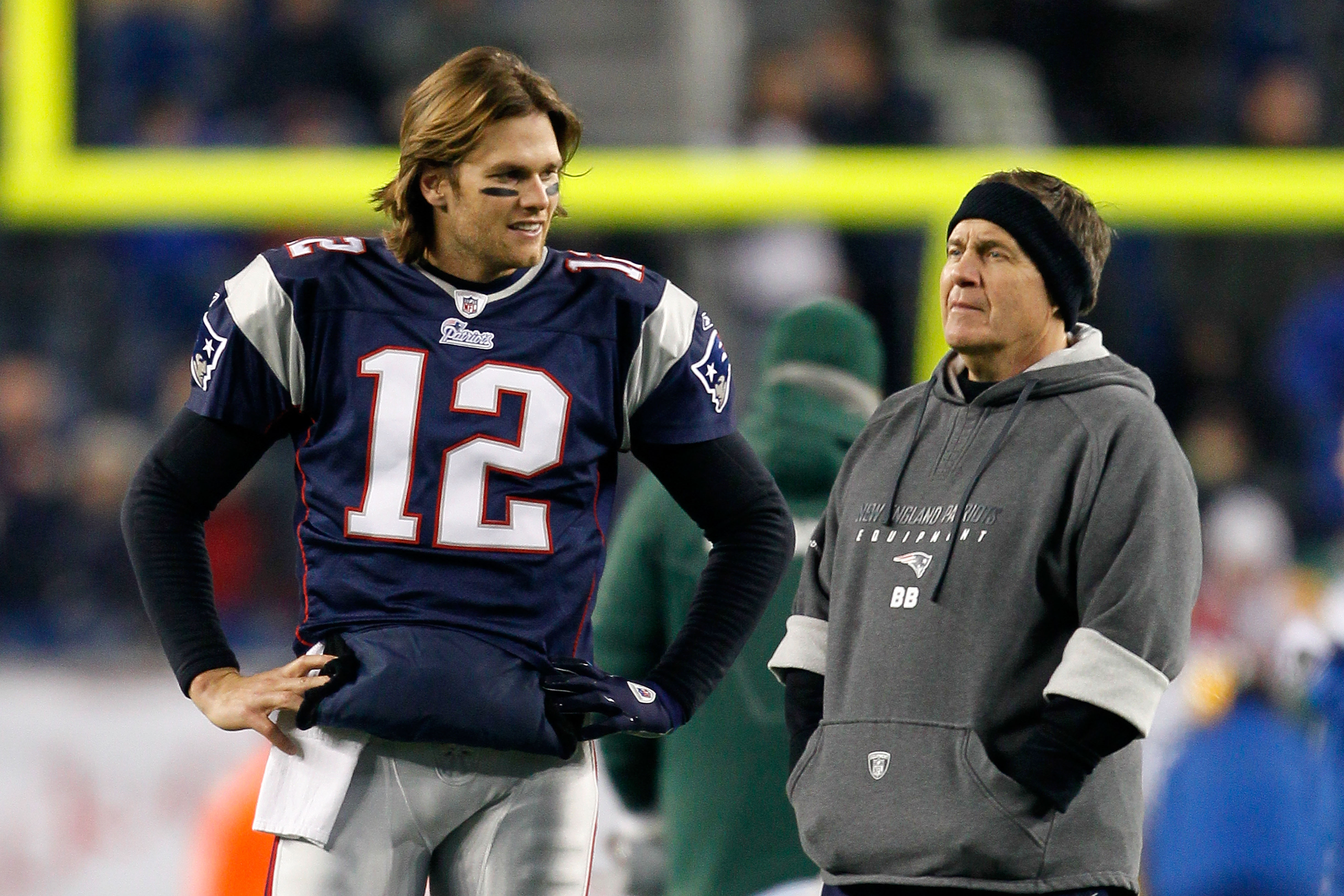 FOXBORO, MA - DECEMBER 19:  Quarterback Tom Brady #12 of the New England Patriots talks with head coach Bill Belichick before playing against the Green Bay Packers at Gillette Stadium on December 19, 2010 in Foxboro, Massachusetts.  The Patriots won the g