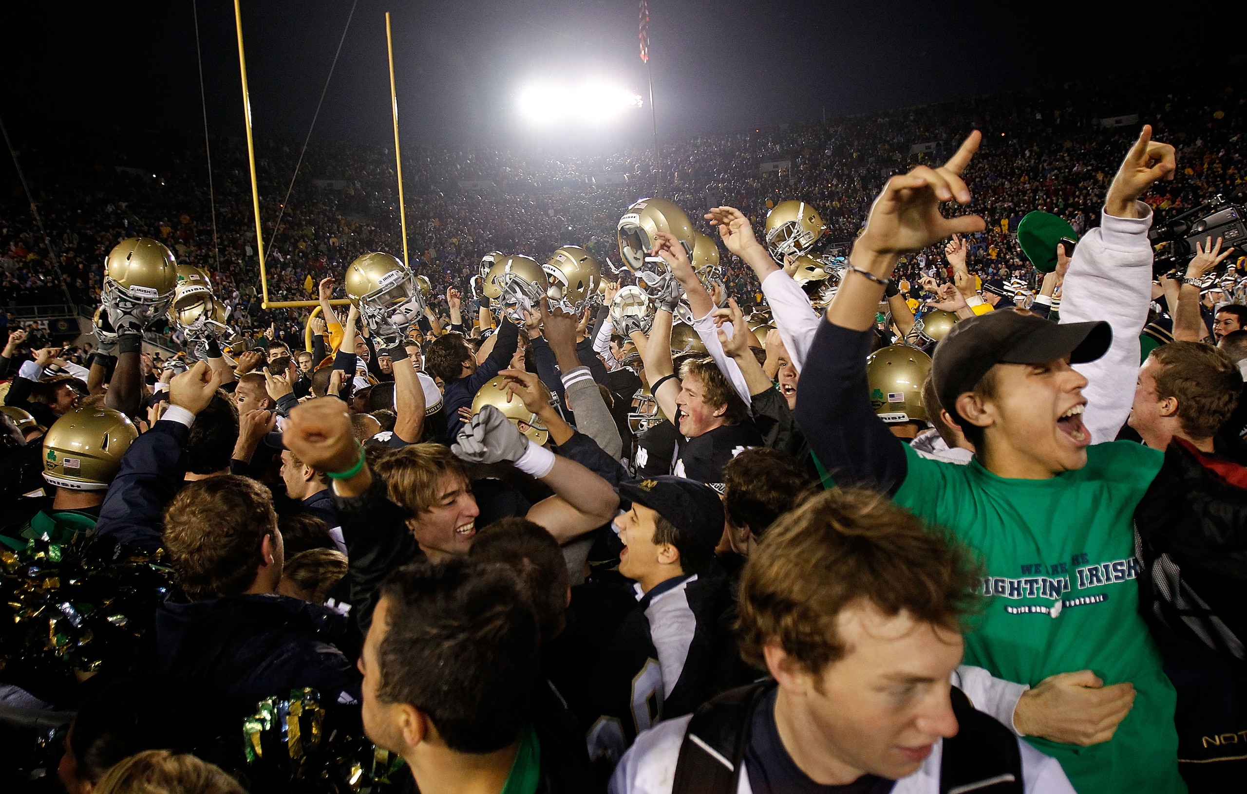 SOUTH BEND, IN - NOVEMBER 13: Players from the Notre Dame Fighting Irish celebrate with fans after a win over the Utah Utes at Notre Dame Stadium on November 13, 2010 in South Bend, Indiana. Notre Dame defeated Utah 28-3. (Photo by Jonathan Daniel/Getty I