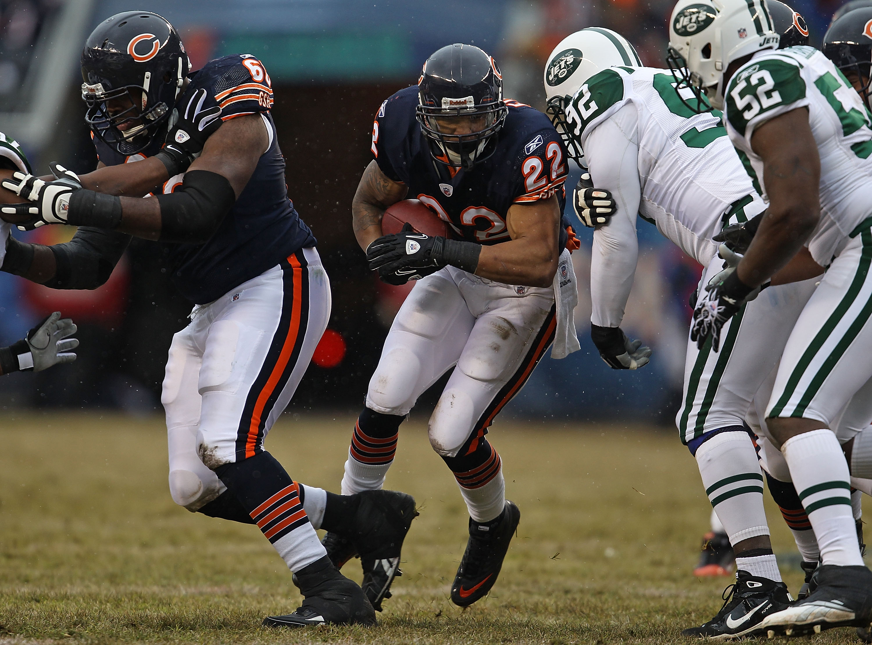 CHICAGO, IL - DECEMBER 26: Matt Forte #22 of the Chicago Bears follows blocker Frank Omiyale #68 as he runs against Shaun Ellis #92 and David Harris #52 of the New York Jets at Soldier Field on December 26, 2010 in Chicago, Illinois. The Bears defeated th