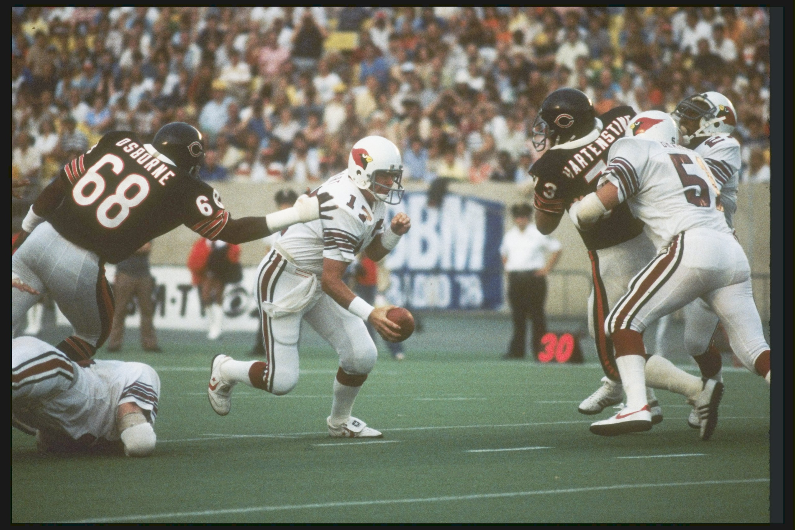 30 Aug 1980:  St Louis Cardinals quarterback Jim Hart avoids the grasp of a Chicago Bears defensive lineman during a preseason game at Soldier Field in Chicago, Illinois.  Mandatory Credit: Jonathan Daniel  /Allsport