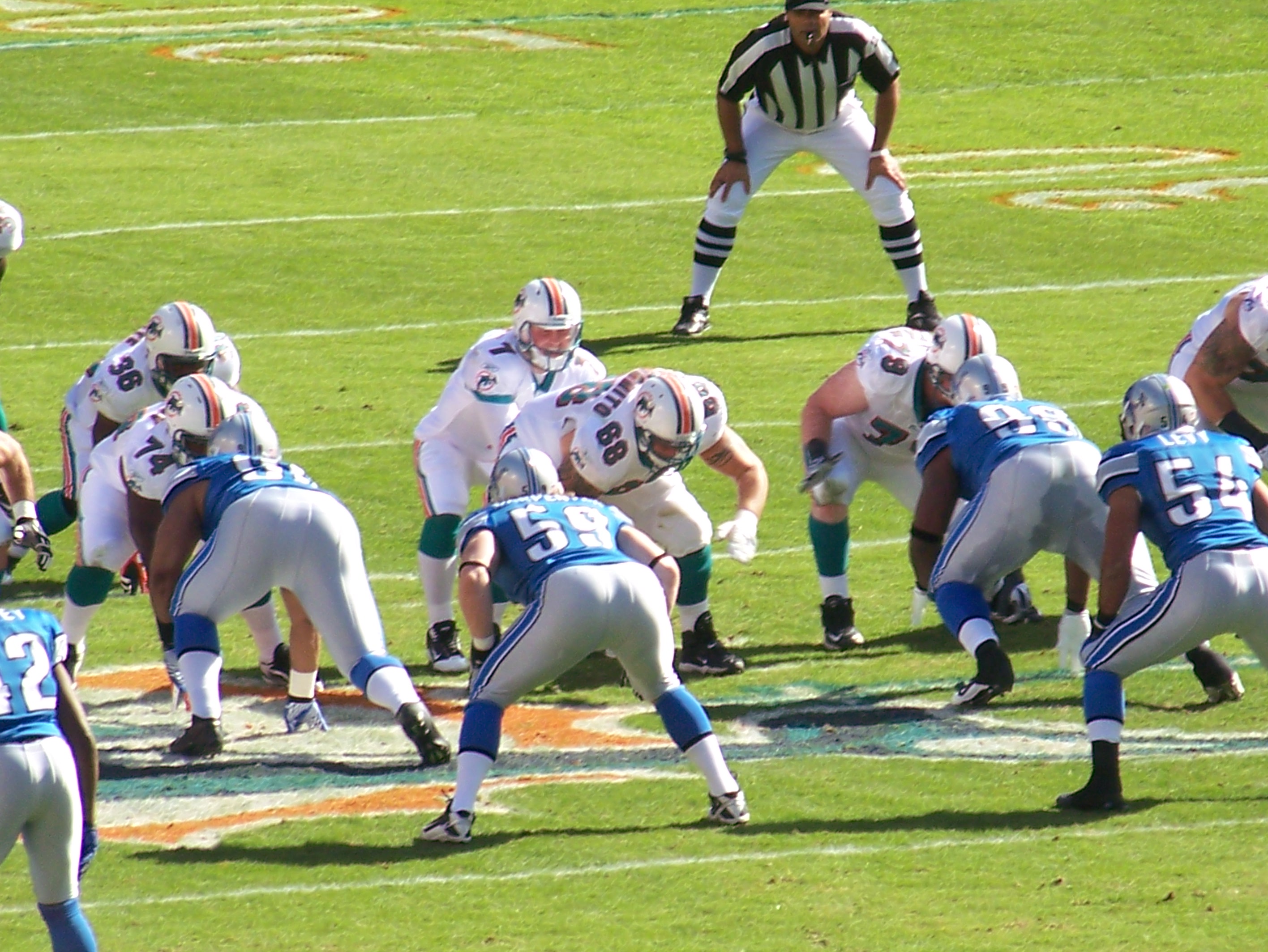 Miami Dolphins running back Ricky Williams (34) runs by Detroit Lions  corner back Amari Spievey (42) in first half action, the Lions take a 34-27  win over the Dolphins at Sun Life