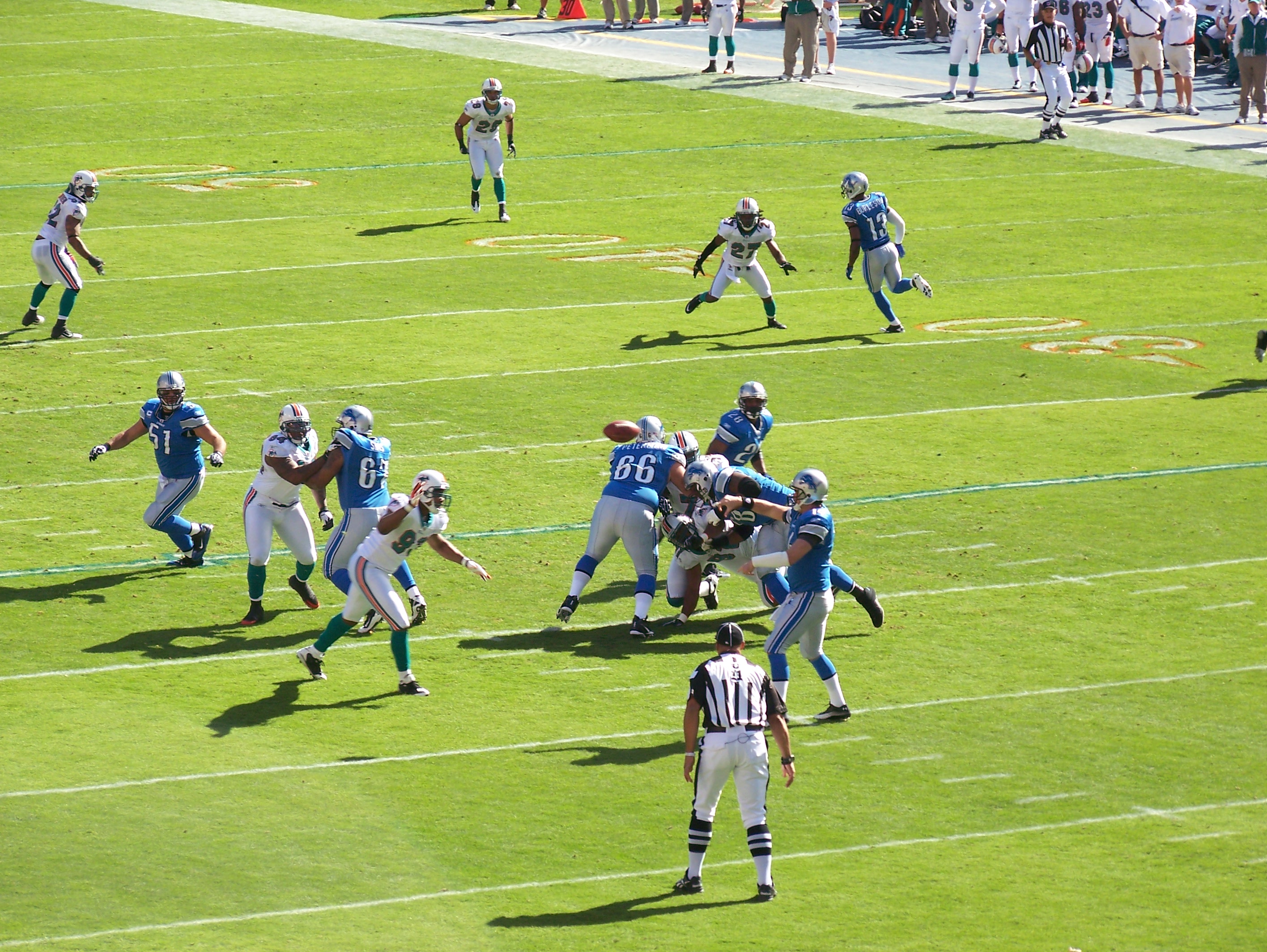 Miami Dolphins running back Ricky Williams (34) runs by Detroit Lions  corner back Amari Spievey (42) in first half action, the Lions take a 34-27  win over the Dolphins at Sun Life