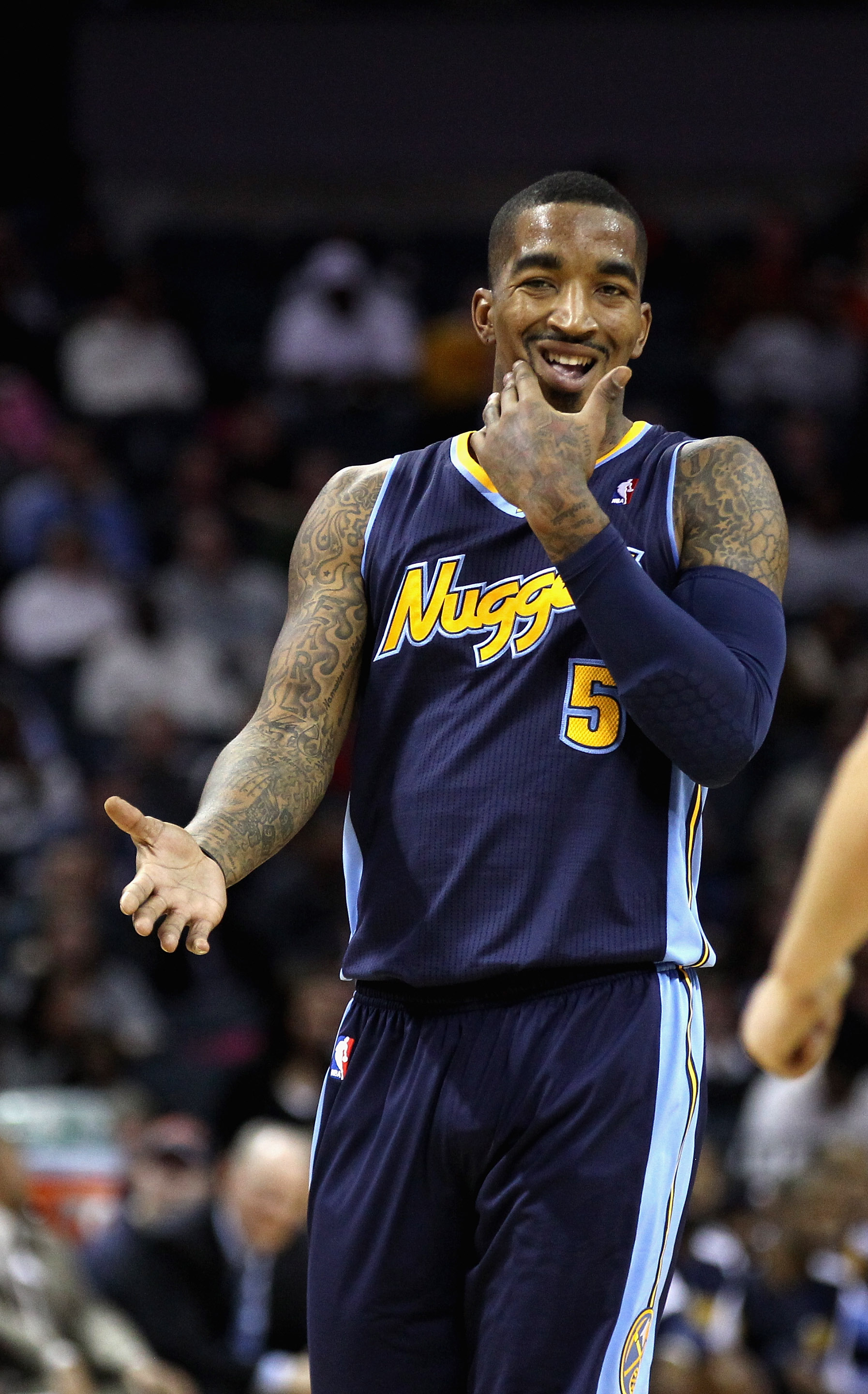 CHARLOTTE, NC - DECEMBER 07:  J.R. Smith #5 of the Denver Nuggets holds his jaw as he reacts to a call against the Charlotte Bobcats during their game at Time Warner Cable Arena on December 7, 2010 in Charlotte, North Carolina.  NOTE TO USER: User express