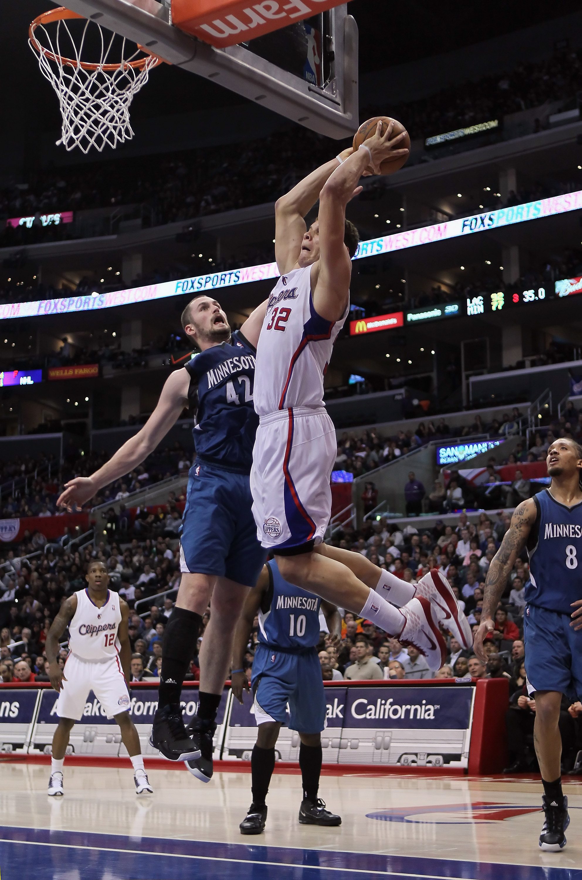 LOS ANGELES, CA - DECEMBER 20:  Blake Griffin #32 of the Los Angeles Clippers drives past Kevin Love #42 of the Minnesota Timberwolves for a dunk during the second half at Staples Center on December 20, 2010 in Los Angeles, California. The Clippers defeat