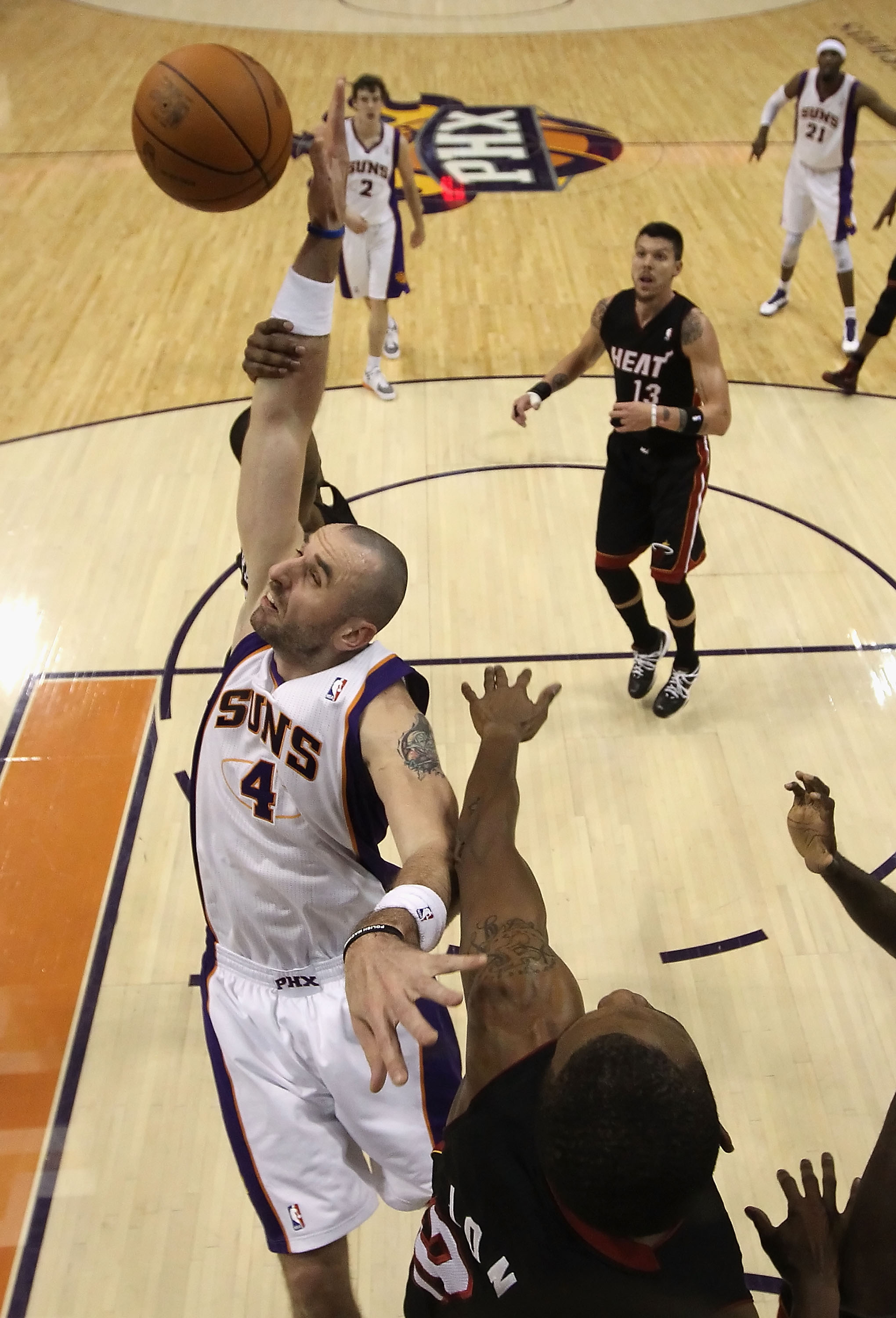 PHOENIX - DECEMBER 23:  Marcin Gortat #4 of the Phoenix Suns jumps for a rebound during the NBA game against the Miami Heat at US Airways Center on December 23, 2010 in Phoenix, Arizona. The Heat defeated the Suns 95-83.  NOTE TO USER: User expressly ackn