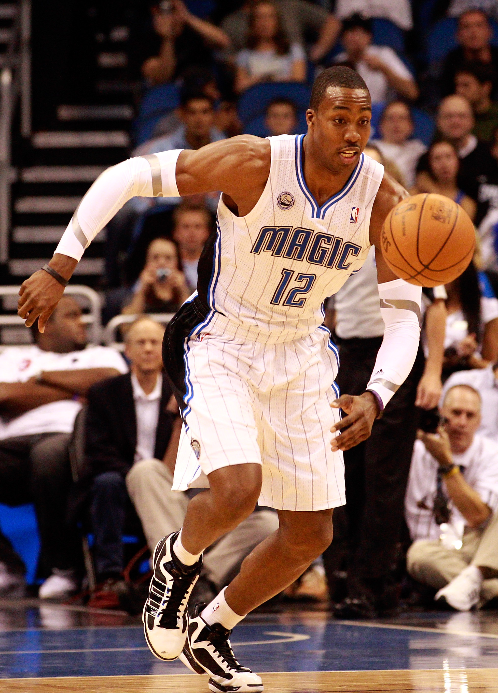 ORLANDO, FL - DECEMBER 18:  Dwight Howard #12 of the Orlando Magic chases down a loose ball during the game against the Philadelphia 76ers at Amway Arena on December 18, 2010 in Orlando, Florida.  NOTE TO USER: User expressly acknowledges and agrees that,