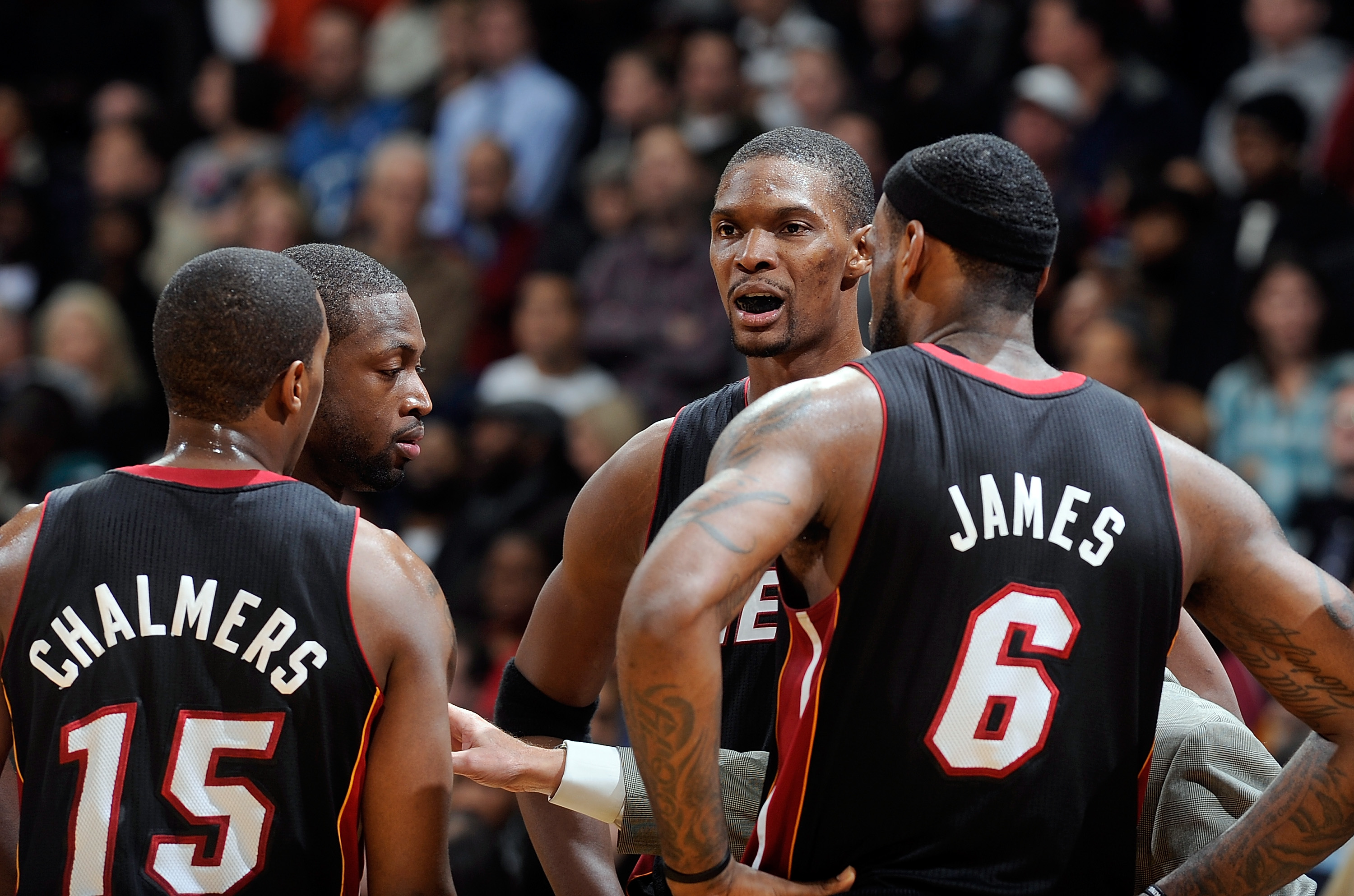 WASHINGTON, DC - DECEMBER 18:  Chris Bosh #1 of the Miami Heat talks with LeBron James #6, Dwyane Wade #3 and Mario Chalmers #15 during the game against the Washington Wizards at the Verizon Center on December 18, 2010 in Washington, DC. NOTE TO USER: Use