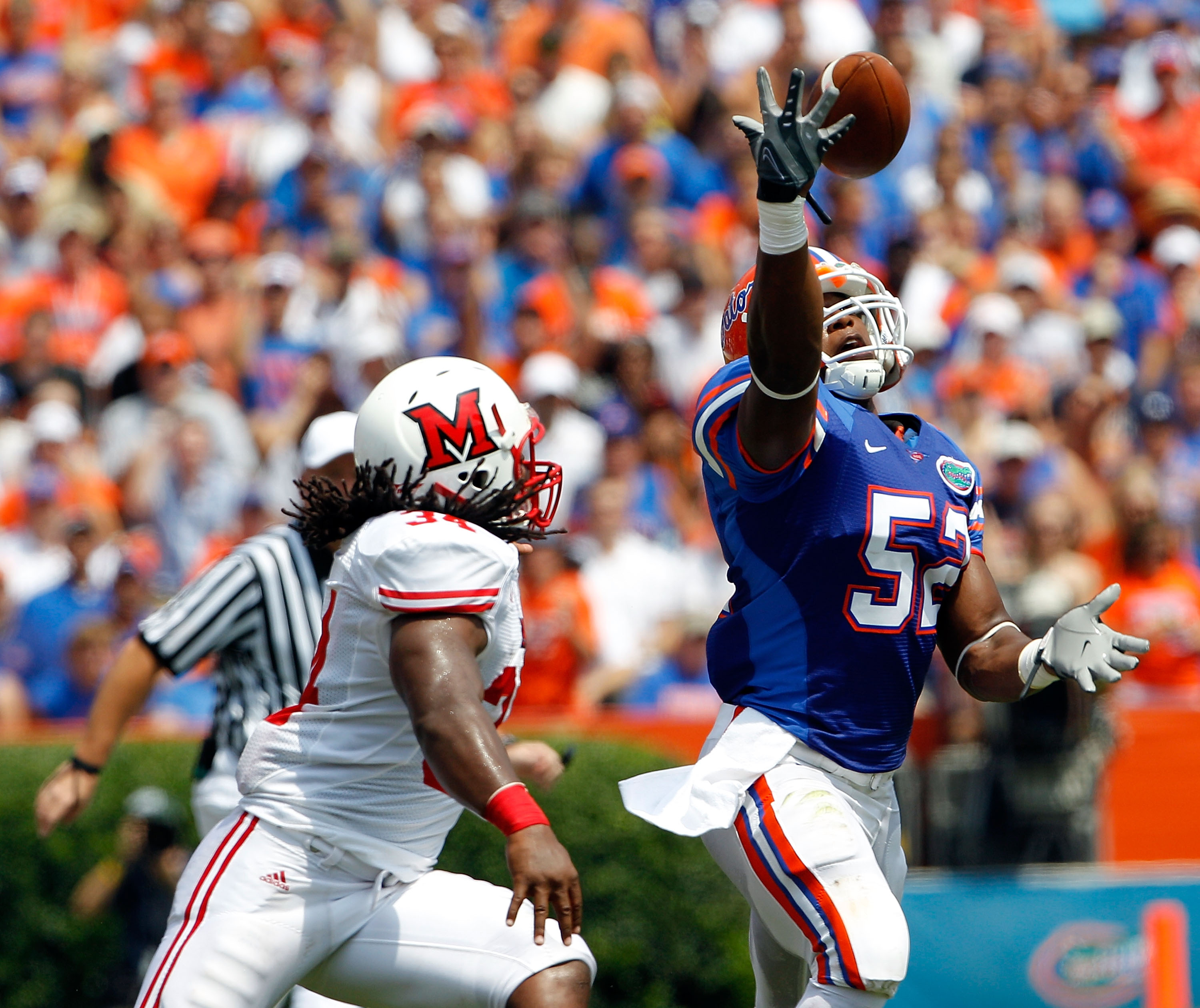 GAINESVILLE, FL - SEPTEMBER 04: Jonathan Bostic #52 of the Florida Gators attempts an interception against the Miami University RedHawks at Ben Hill Griffin Stadium on September 4, 2010 in Gainesville, Florida. (Photo by Sam Greenwood/Getty Images)