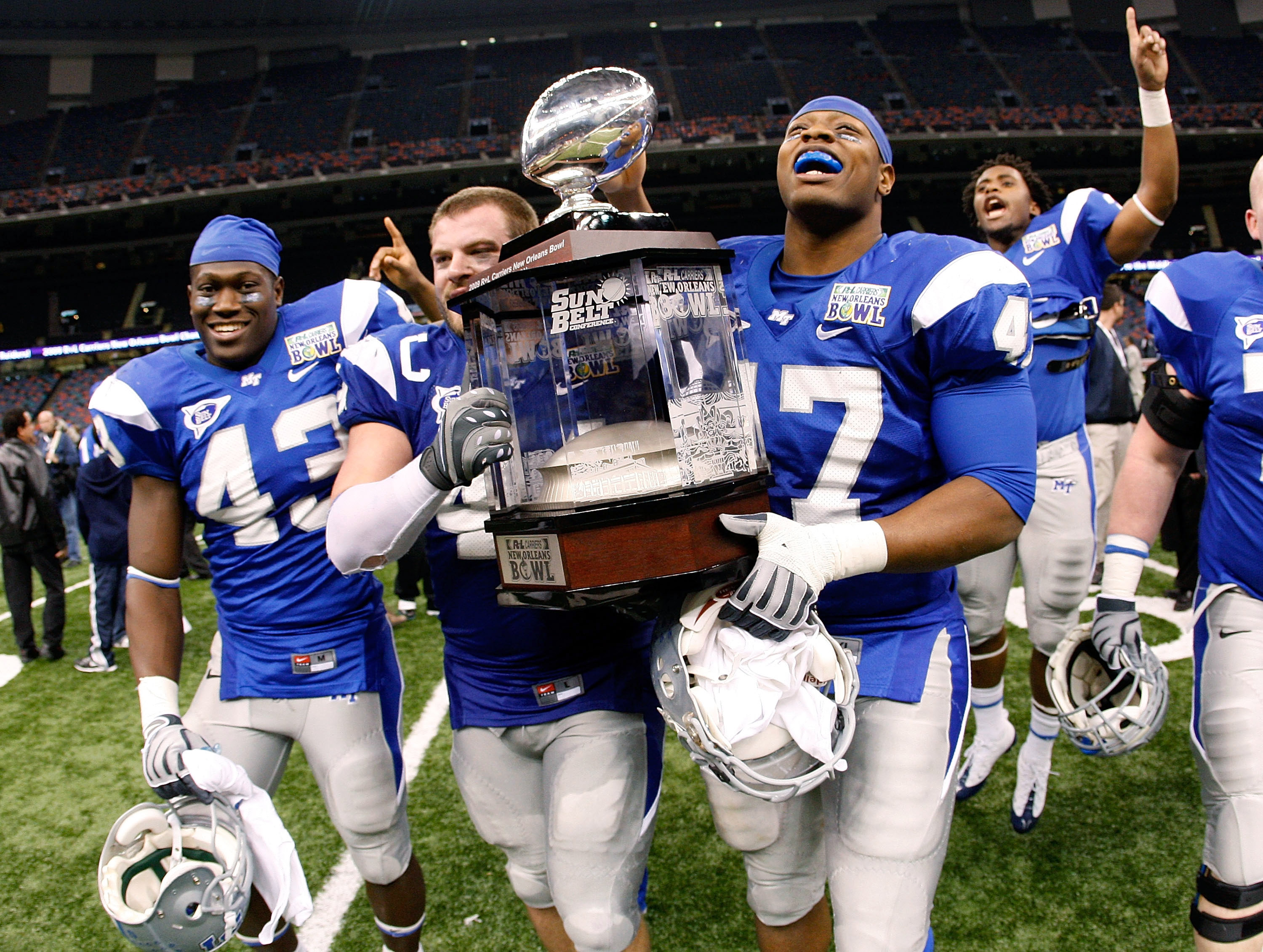 NEW ORLEANS - DECEMBER 20: Members of the Middle Tennessee Blue Raiders celebrate with the trophy after defeating the Southern Miss Eagles 42-32 during the R+L Carriers New Orleans Bowl at the Louisiana Superdome on December 20, 2009 in New Orleans, Loui