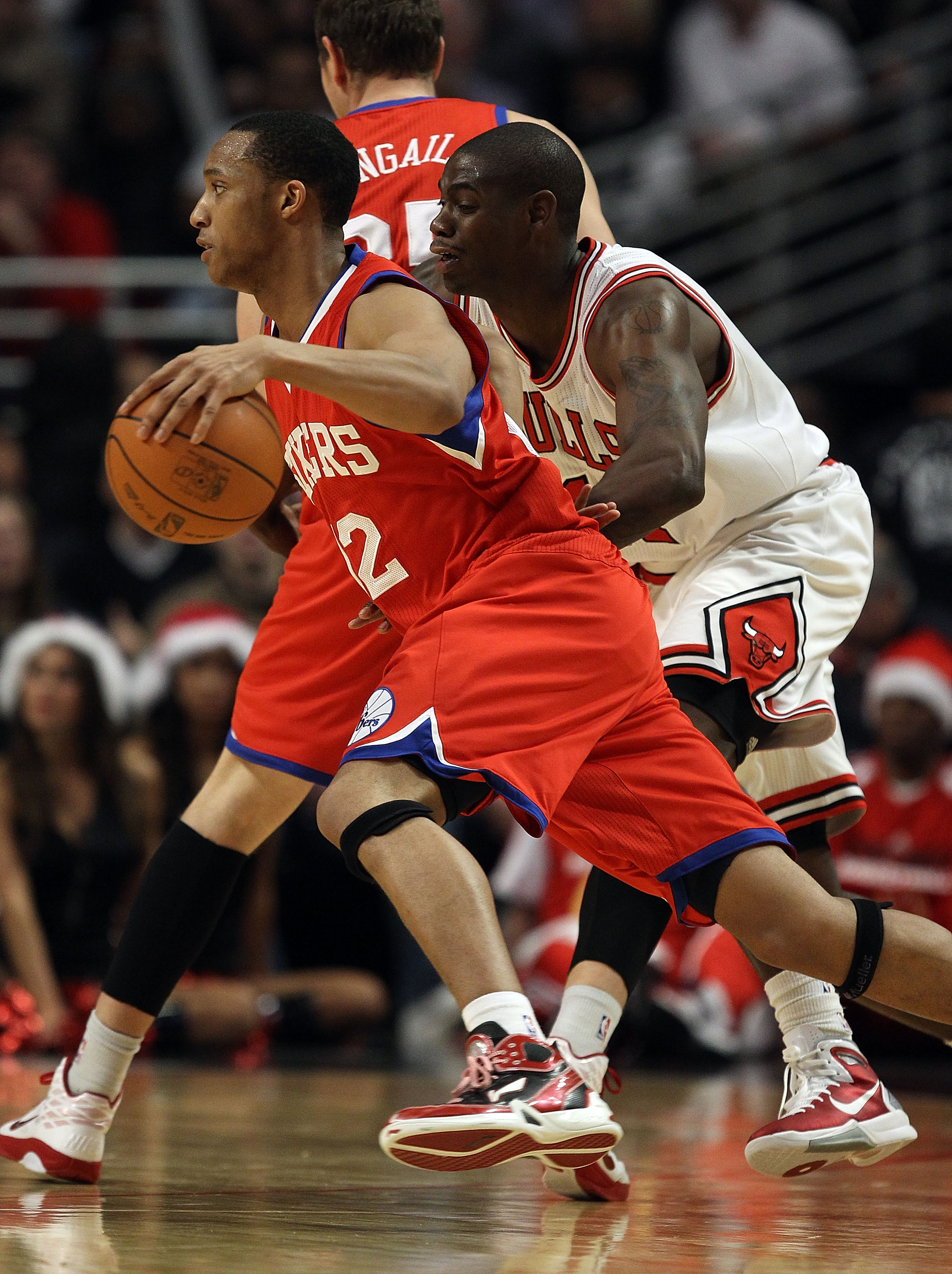 CHICAGO, IL - DECEMBER 21: Evan Turner #12 of the Philadelphia 76ers moves past Ronnie Brewer #11 of the Chicago Bulls at the United Center on December 21, 2010 in Chicago, Illinois. The Bulls defeated the 76ers 121-76. NOTE TO USER: User expressly acknow