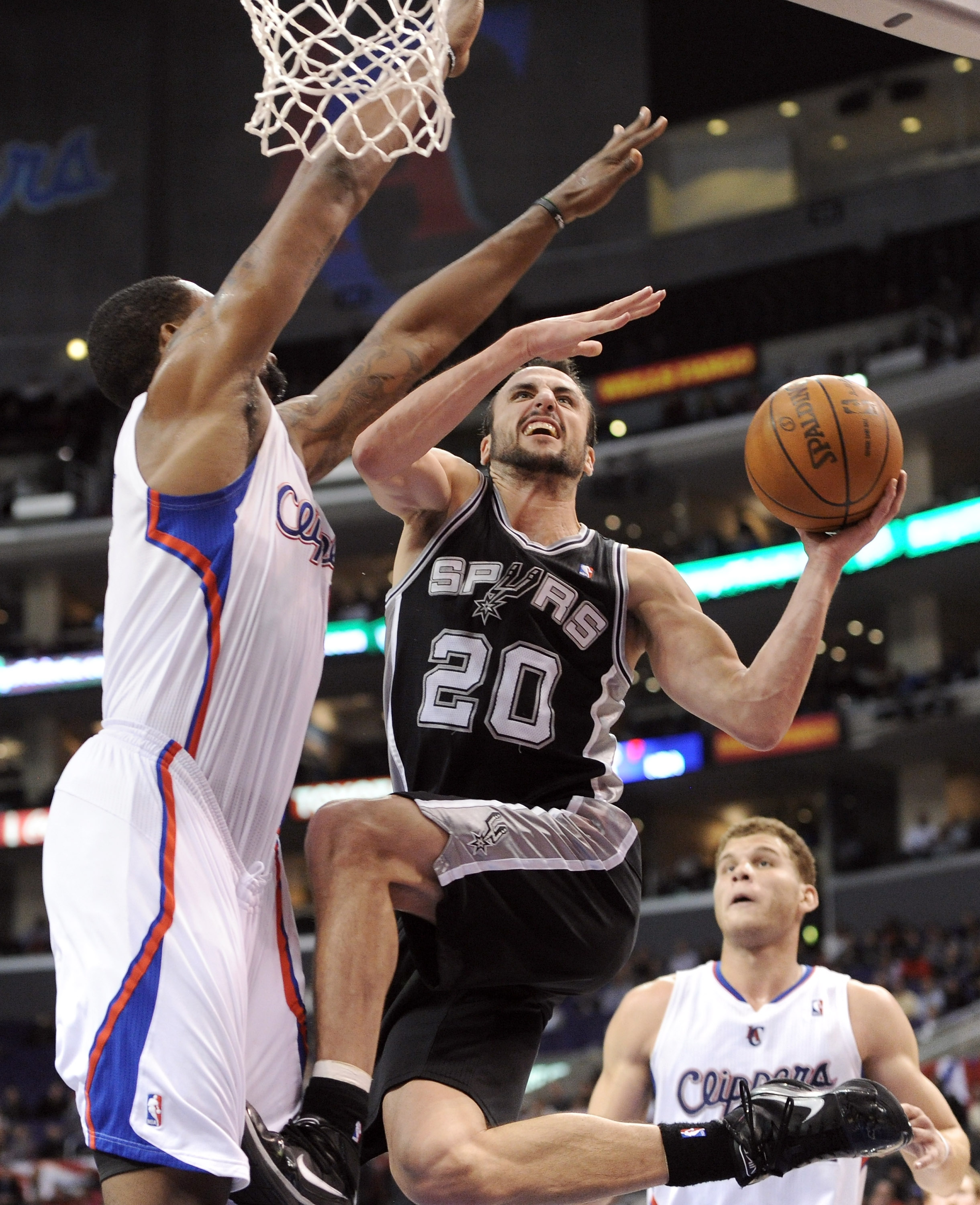 LOS ANGELES, CA - DECEMBER 01:  Manu Ginobili #20 of the San Antonio Spurs drives on DeAndre Jordan #9 of the Los Angeles Clippers during the game at the Staples Center on December 1, 2010 in Los Angeles, California.  NOTE TO USER: User expressly acknowle