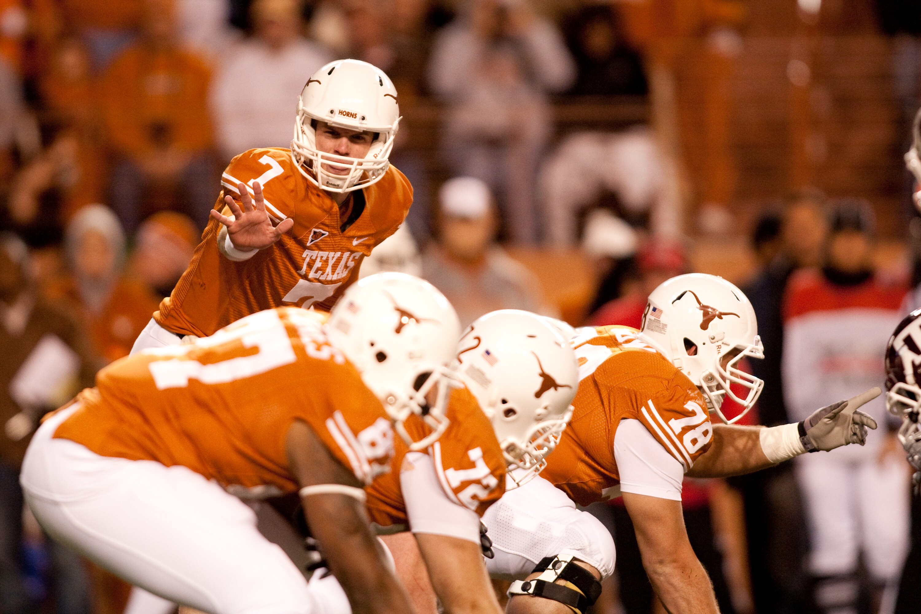 AUSTIN, TX - NOVEMBER 25:  University of Texas quarterback Garrett Gilbert #7 calls a play during the first half against Texas A&M at Darrell K. Royal-Texas Memorial Stadium on November 25, 2010 in Austin, Texas. (Photo by Darren Carroll/Getty Images)