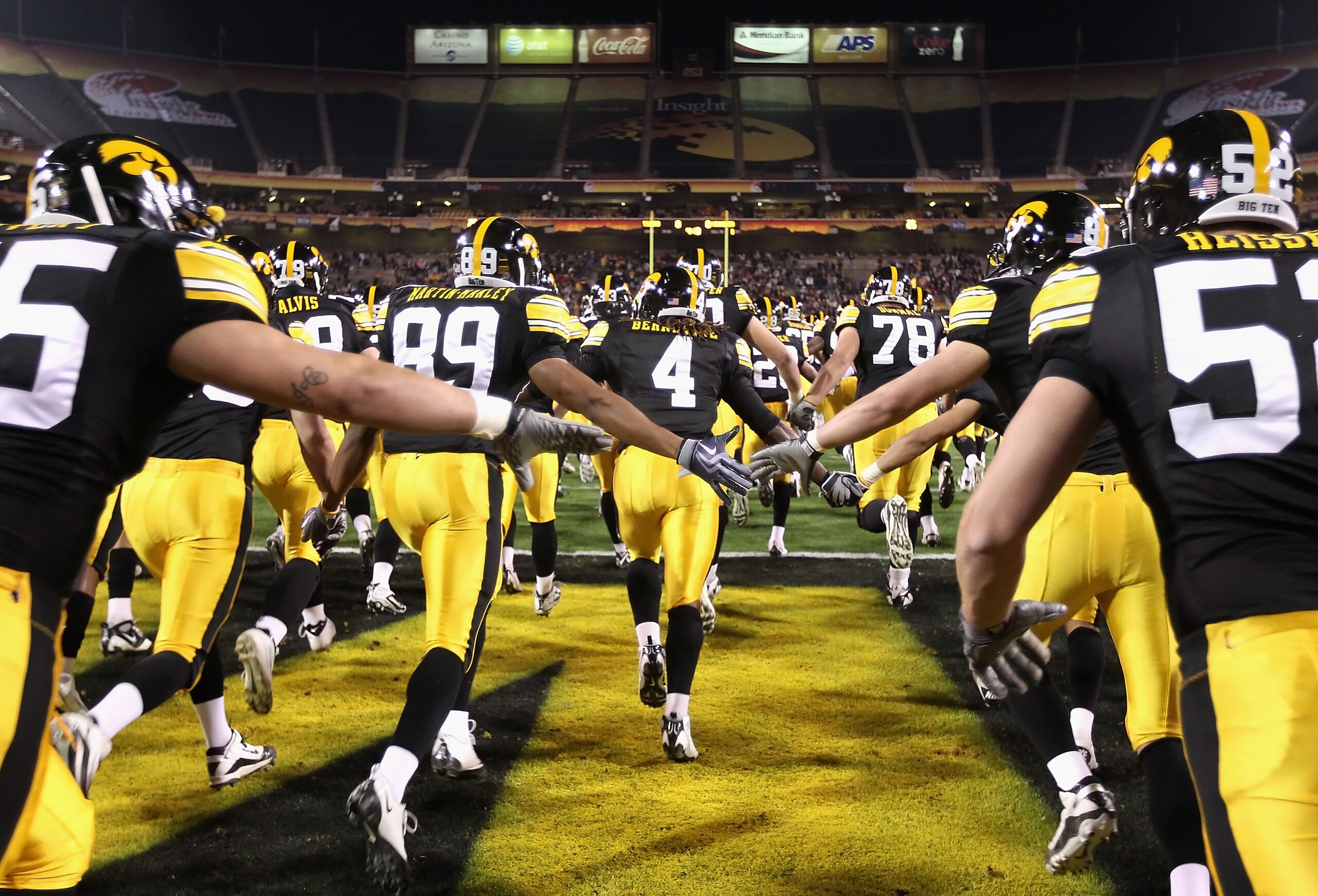 TEMPE, AZ - DECEMBER 28:  The Iowa Hawkeyes run out onto the field before the Insight Bowl against the Missouri Tigers at Sun Devil Stadium on December 28, 2010 in Tempe, Arizona.  The Hawkeyes defeated the Tigers 27-24.  (Photo by Christian Petersen/Gett