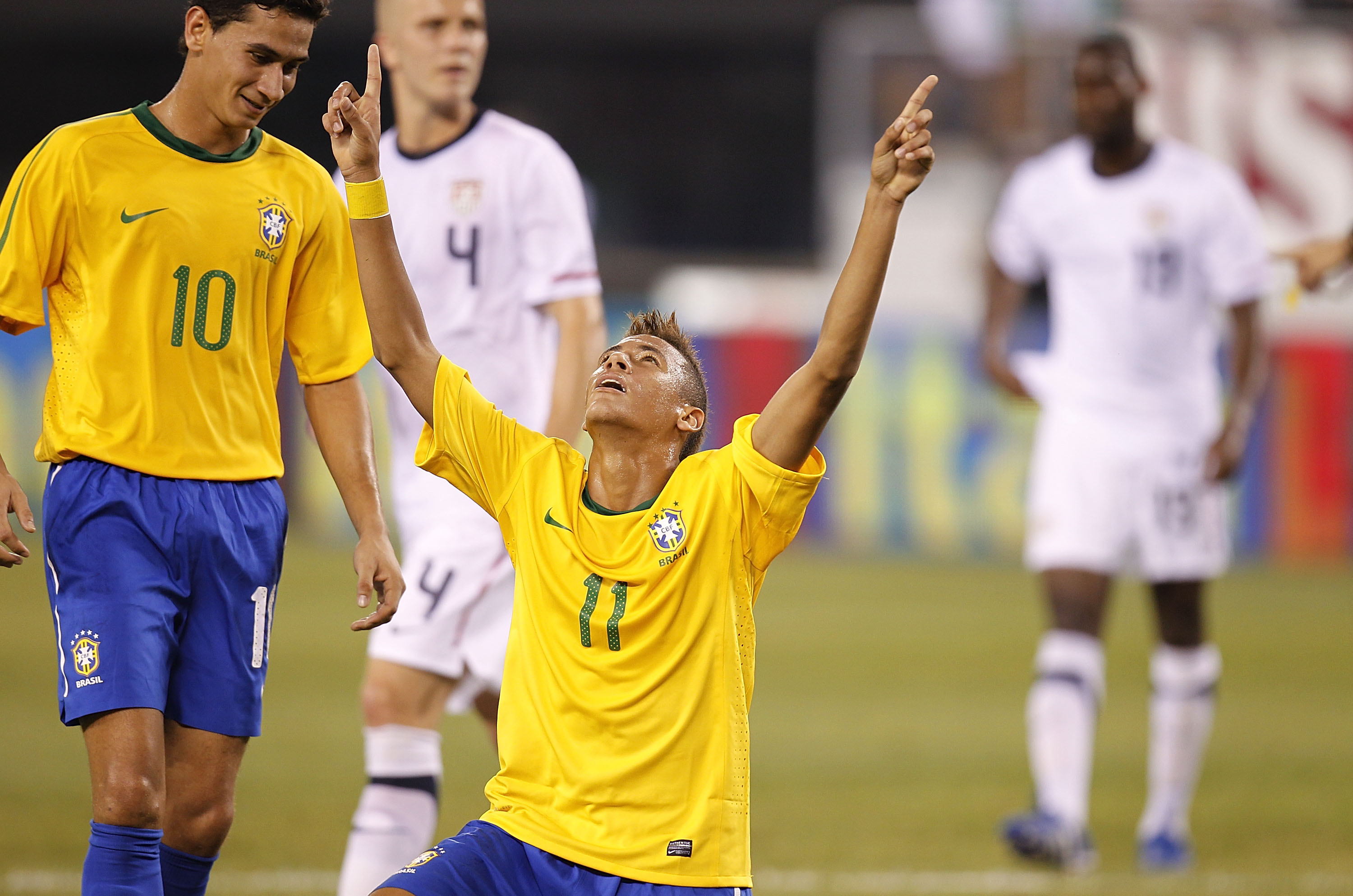 EAST RUTHERFORD, NJ - AUGUST 10:  Neymar #11 and Paulo Henrique Ganso #10 of Brazil celebrate Neymar's goal against the U.S. in the first half of a friendly match at the New Meadowlands on August 10, 2010 in East Rutherford, New Jersey.  (Photo by Jeff Ze