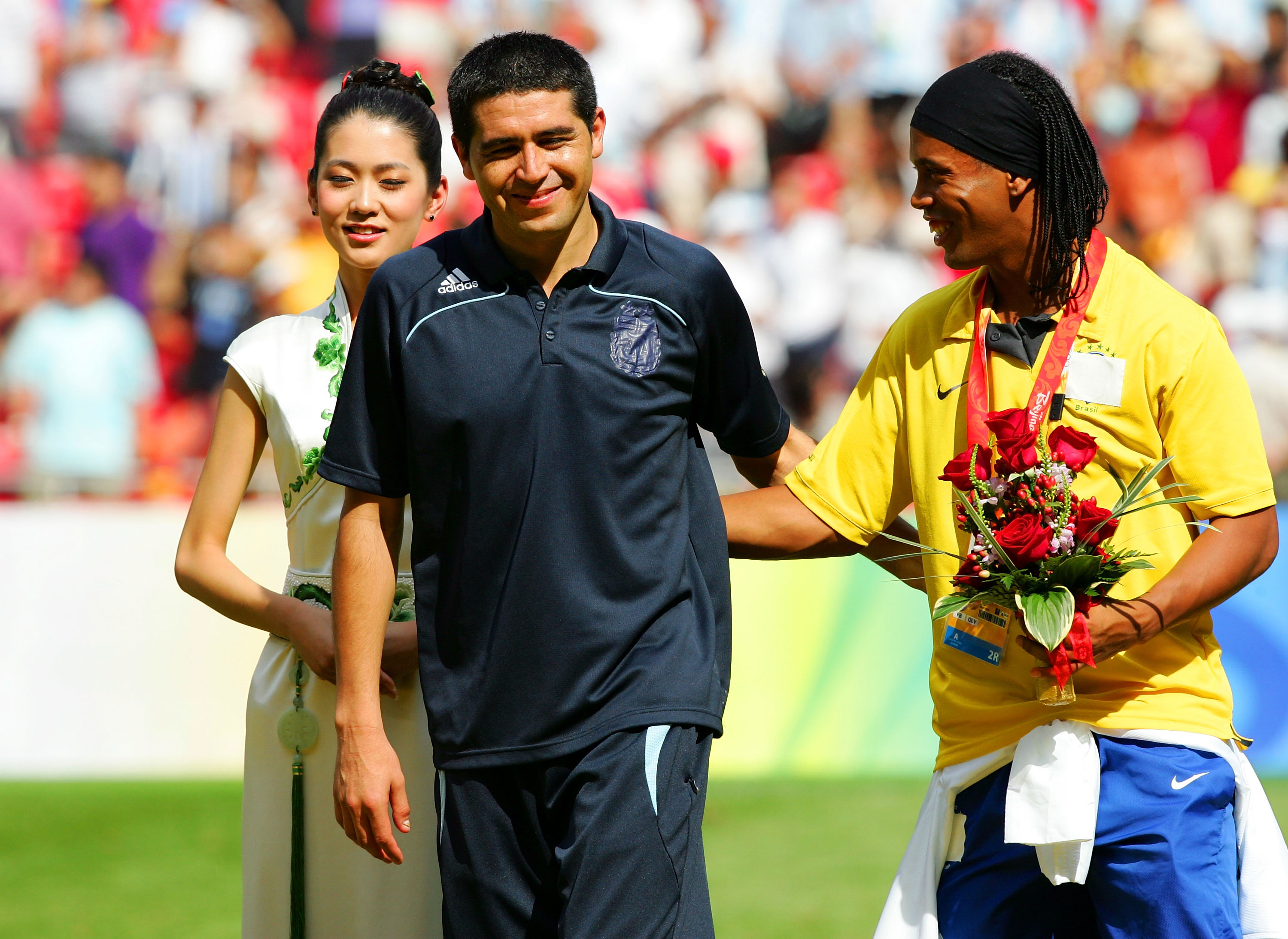 BEIJING - AUGUST 23: Juan Riquelme of Argentina and Ronaldinho of Brazil share a joke during the medal ceremony for the Men's Final between Nigeria and Argentina at the National Stadium on Day 15 of the Beijing 2008 Olympic Games on August 23, 2008 in Bei