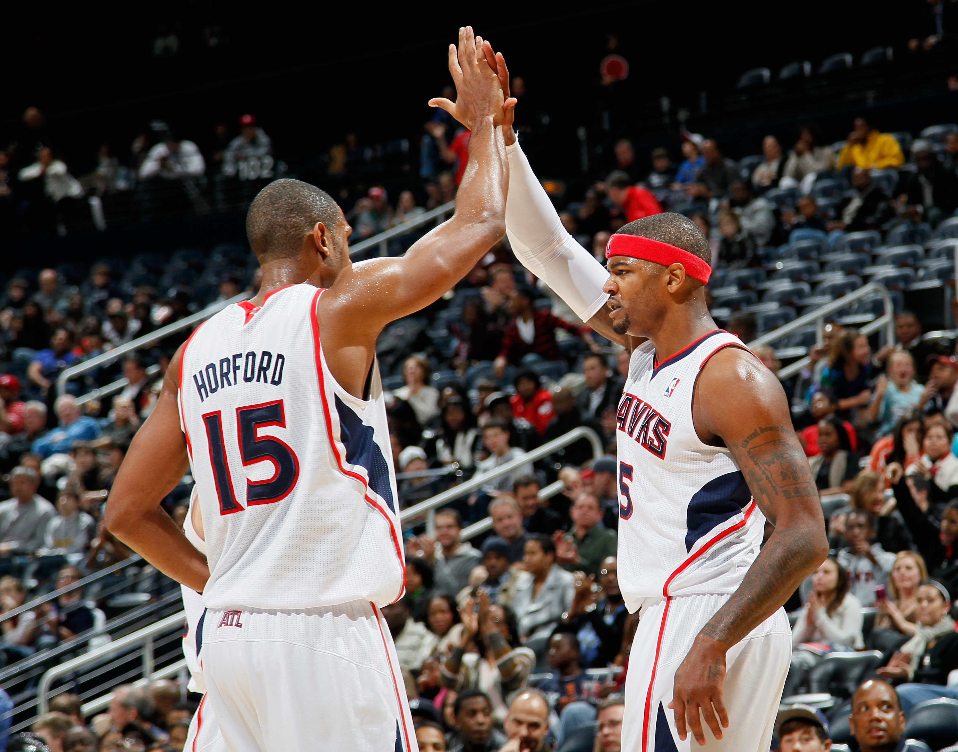 ATLANTA, GA - DECEMBER 11:  Josh Smith #5 and Al Horford #15 of the Atlanta Hawks react after Smith's basket and foul against the Indiana Pacers at Philips Arena on December 11, 2010 in Atlanta, Georgia.  NOTE TO USER: User expressly acknowledges and agre