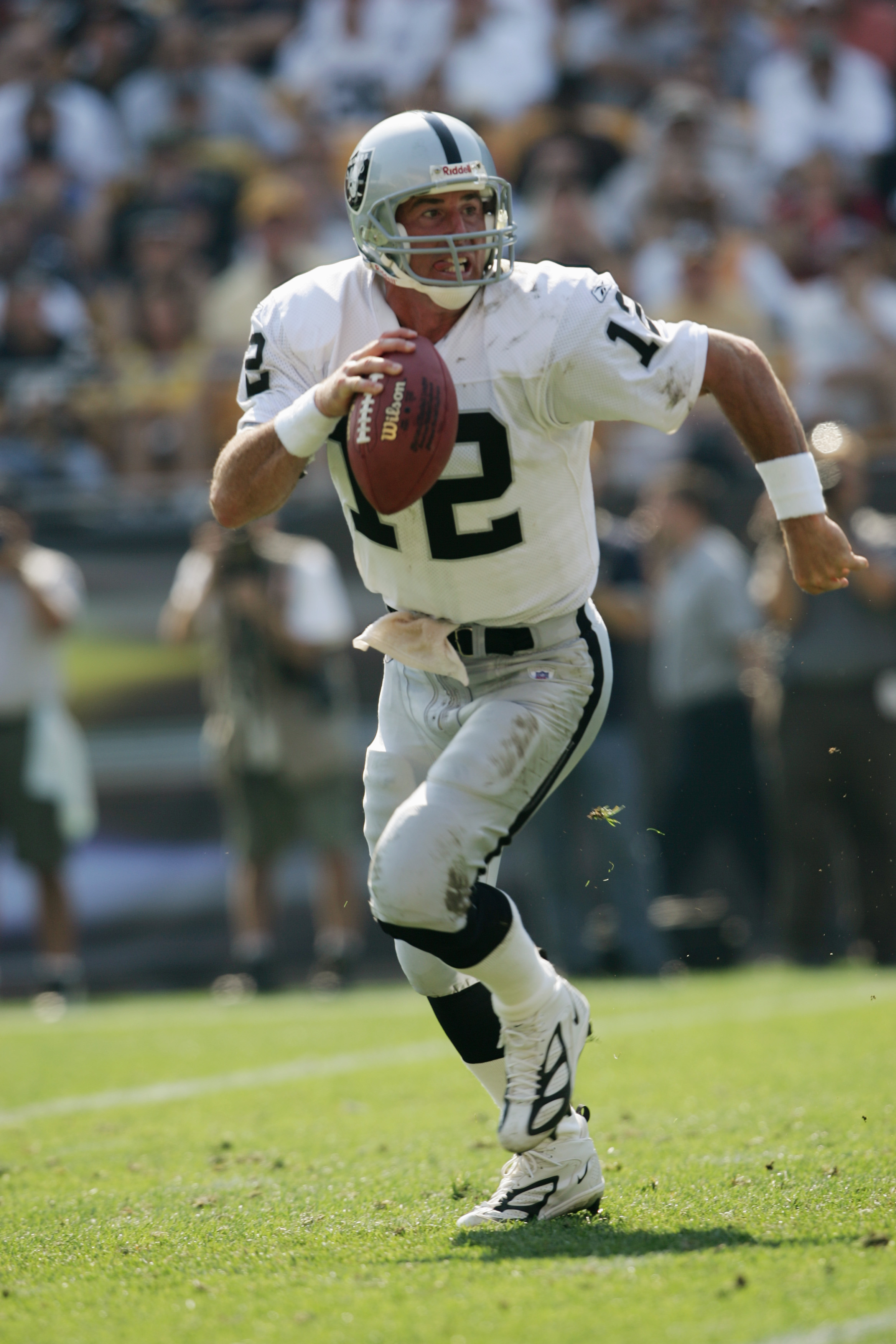 PITTSBURGH - SEPTEMBER 12:  Quarterback Rich Gannon #12 of the Oakland Raiders scrambles with the ball against the Pittsburgh Steelers during the game at Heinz Field on September 12, 2004 in Pittsburgh, Pennsylvania. The Steelers defeated the Raiders 24-2