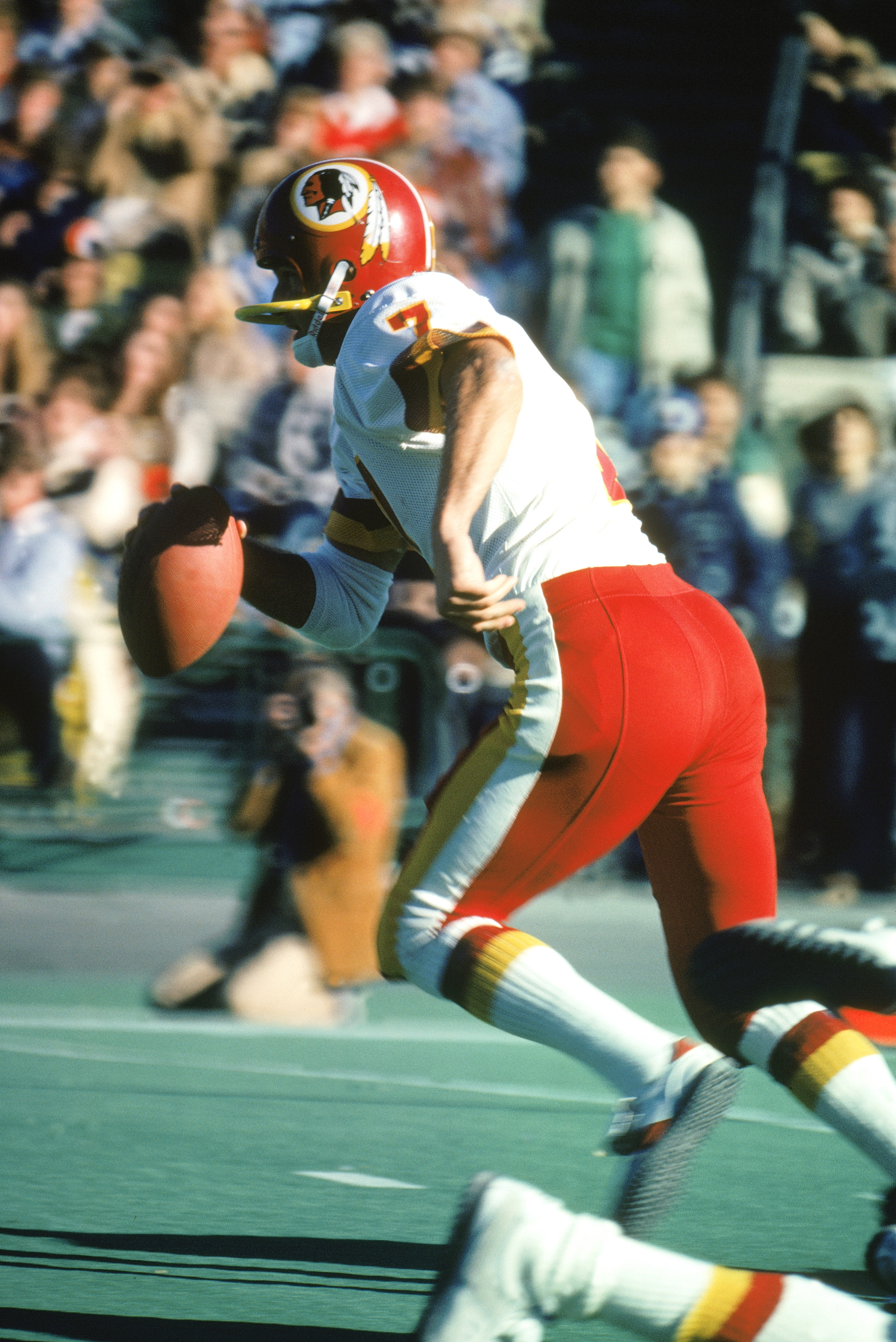 CHICAGO -1980:  Joe Theismann #7 of the Washington Redskins runs as he looks to pass during the 1980 NFL season game against the Chicago Bears at Soldier Field in Chicago, Illinois. The Bears defeated the Redskins 35-21. (Photo by: Jonathan Daniel/Getty I