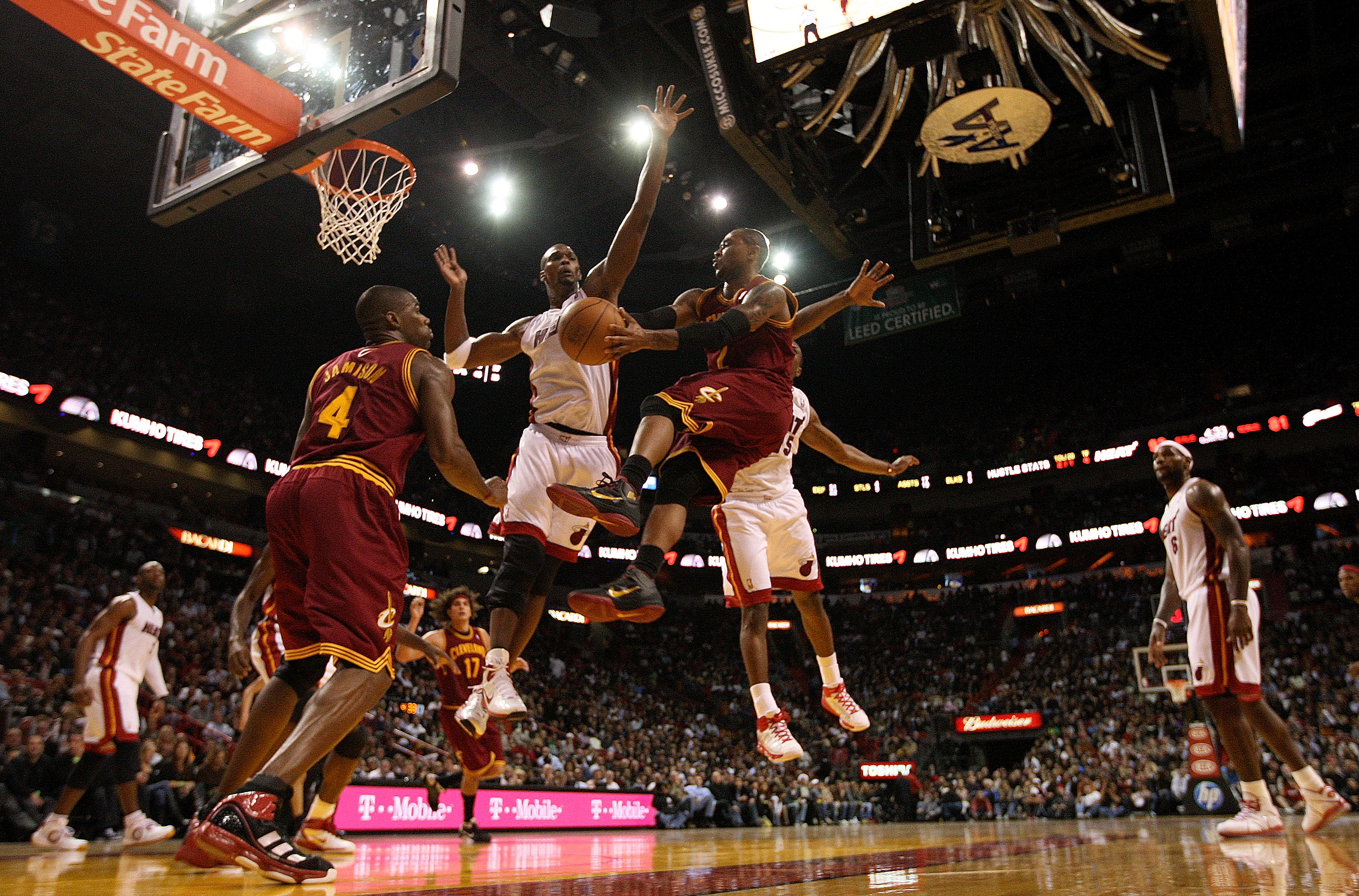 MIAMI, FL - DECEMBER 15:  Mo Wlliams #2 of the Cleveland Cavaliers passes around Chris Bosh #1 of the Miami Heat during a game  at American Airlines Arena on December 15, 2010 in Miami, Florida. NOTE TO USER: User expressly acknowledges and agrees that, b