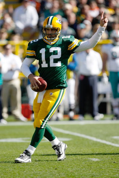 GREEN BAY, WI - OCTOBER 17: Aaron Rogers #12 of the Green Bay Packers points as he drops back to pass against the Miami Dolphins at Lambeau Field on October 17, 2010 in Green Bay, Wisconsin. (Photo by Scott Boehm/Getty Images)