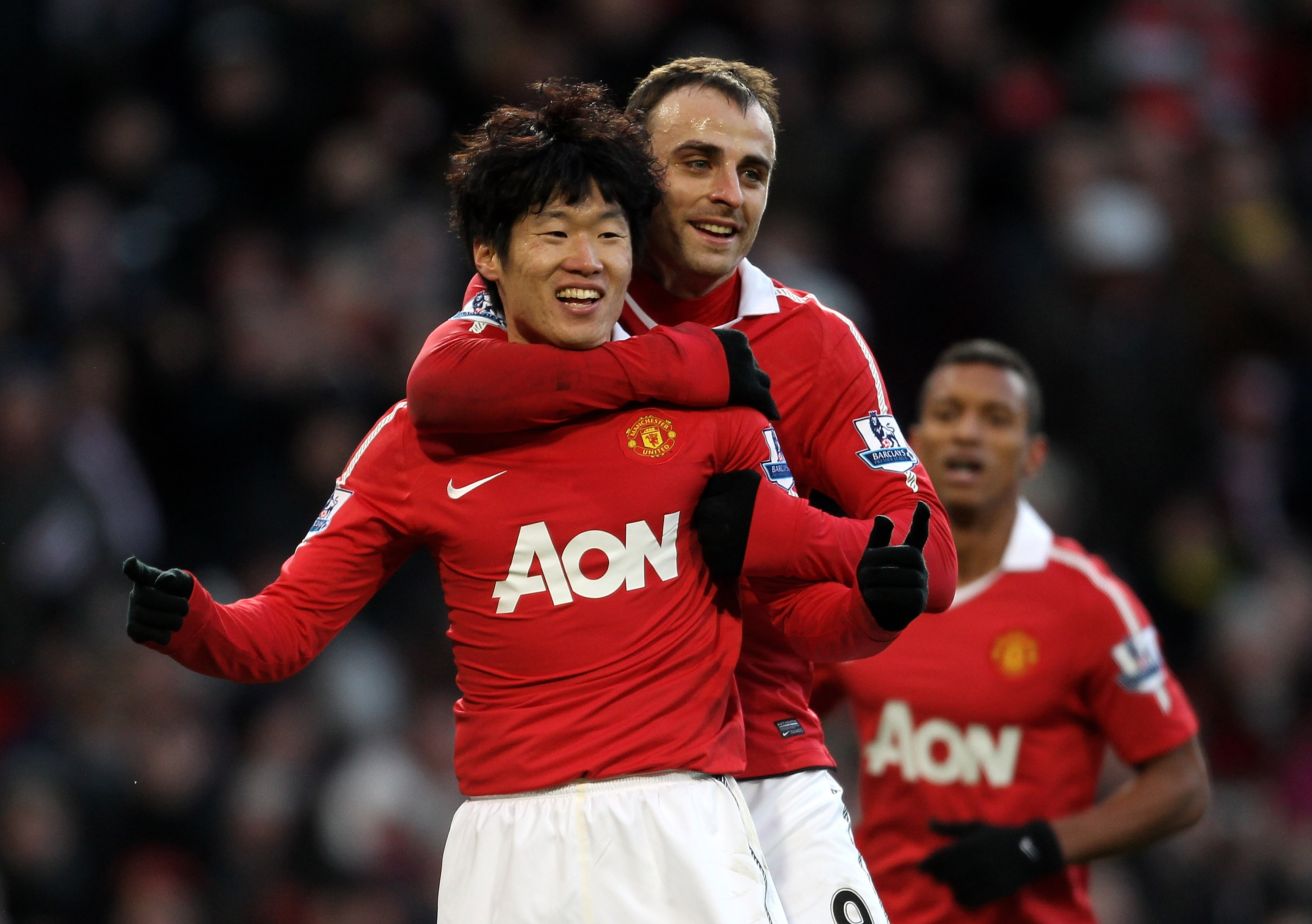 MANCHESTER, ENGLAND - NOVEMBER 27:  Ji-Sung Park (L) of Manchester United celebrates scoring his team's second goal with team mate Dimitar Berbatov  during the Barclays Premier League match between Manchester United and Blackburn Rovers at Old Trafford on