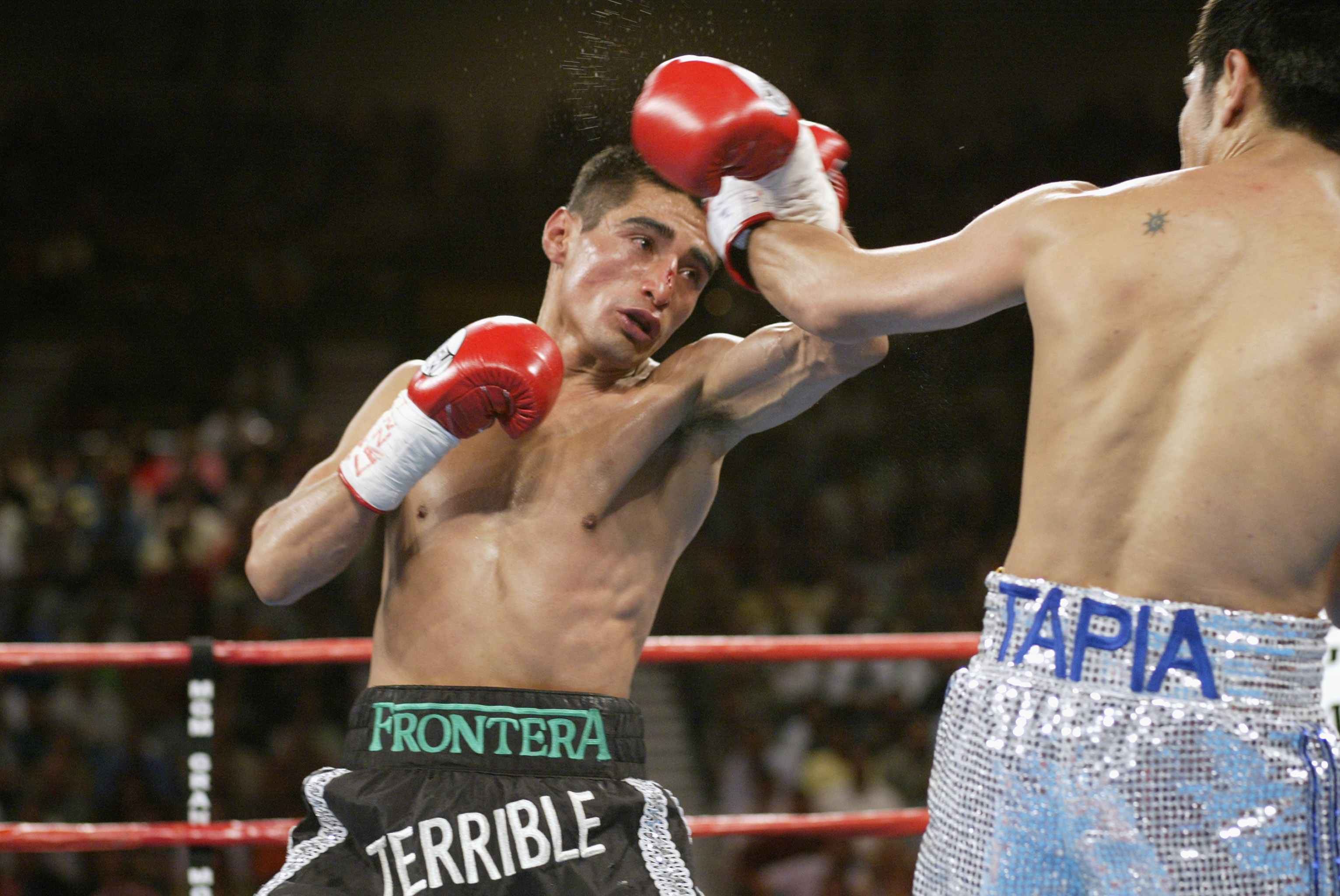 Las Vegas - June 22:   Erik Morales tries to counterattack against Marco Antonio Barrera during their World Featherweight Championship fight on June 22, 2002 at the MGM Grand Hotel/Casino in Las Vegas. (Photo by Jed Jacobsohn/Getty Images)