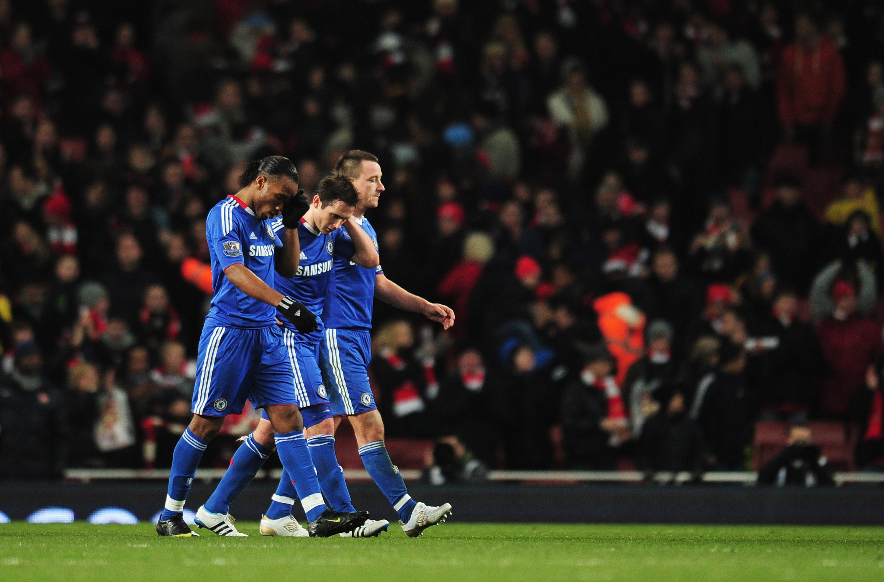 LONDON, ENGLAND - DECEMBER 27: (L-R) Didier Drogba, Frank Lampard and John Terry of Chelsea walk off dejected after the Barclays Premier League match between Arsenal and Chelsea at the Emirates Stadium on December 27, 2010 in London, England.  (Photo by S