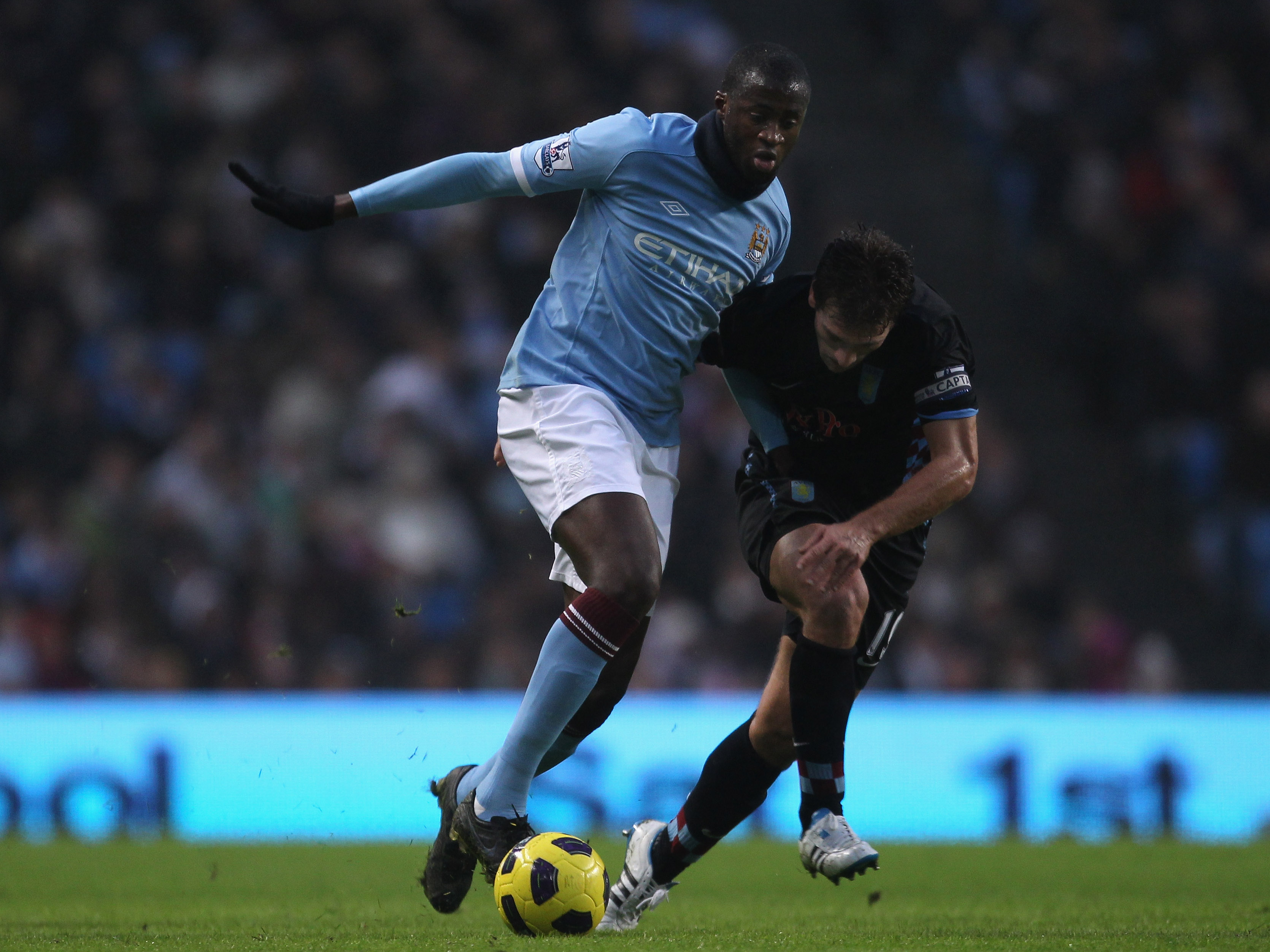 MANCHESTER, ENGLAND - DECEMBER 28:  Yaya Toure of Manchester City holds off a challenge from Stiliyan Petrov of Aston Villa during the Barclays Premier League match between Manchester City and Aston Villa at the City of Manchester Stadium on December 28,