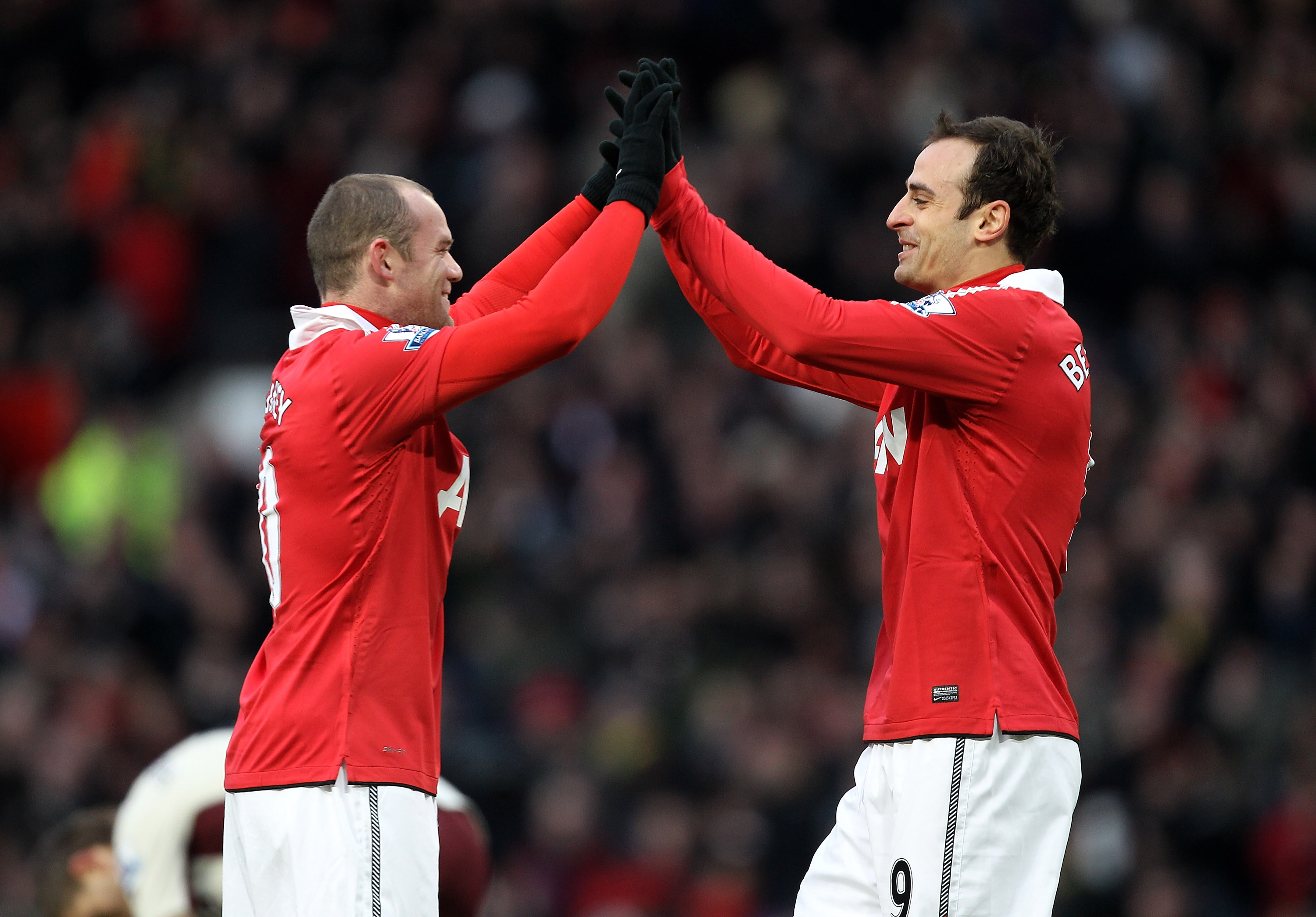 MANCHESTER, ENGLAND - DECEMBER 26:  Dimitar Berbatov of Manchester United celebrates scoring the opening goal with team mate Wayne Rooney (L) during the Barclays Premier League match between Manchester United and Sunderland at Old Trafford on December 26,