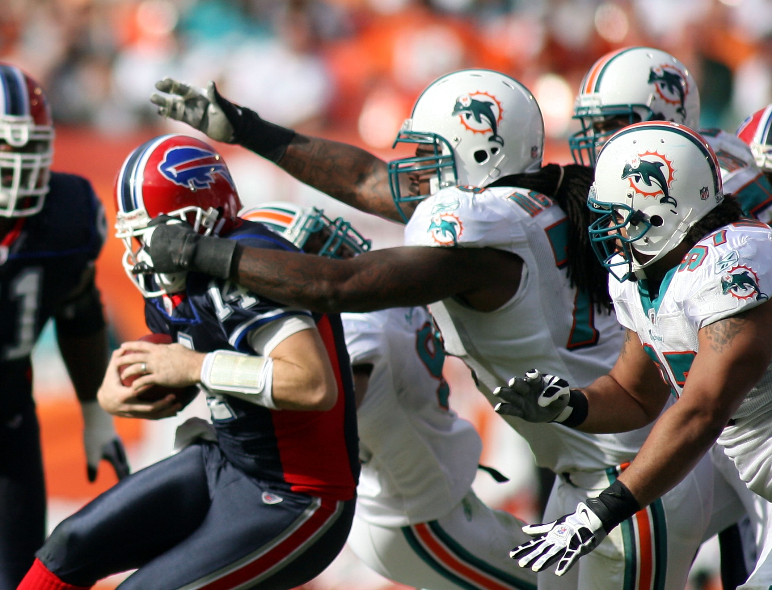 MIAMI - DECEMBER 19:  Defensive tackle Tony McDaniel #94 of the Miami Dolphins sacks quarterback Ryan Fitzpatrick #14 of the Buffalo Bills at Sun Life Stadium on December 19, 2010 in Miami, Florida. The Bills defeated the Dolphins 17-14.  (Photo by Marc S