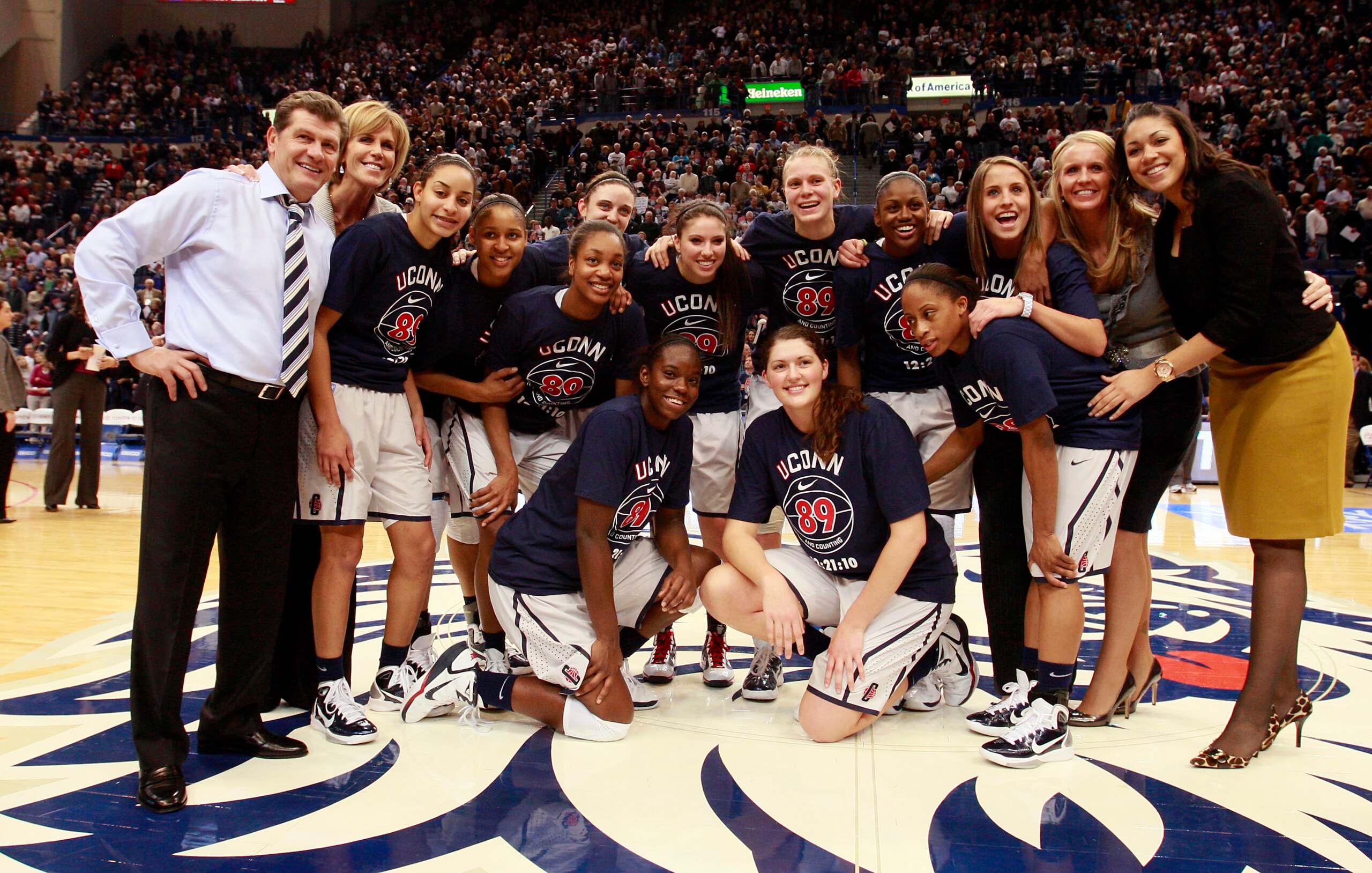HARTFORD, CT - DECEMBER 21:  Coach Geno Auriemma of Connecticut and his team pose for a picture after defeating Florida State on December 21, 2010 in Hartford, Connecticut. Connecticut set a record with 89 straight wins without a defeat. Connecticut set a