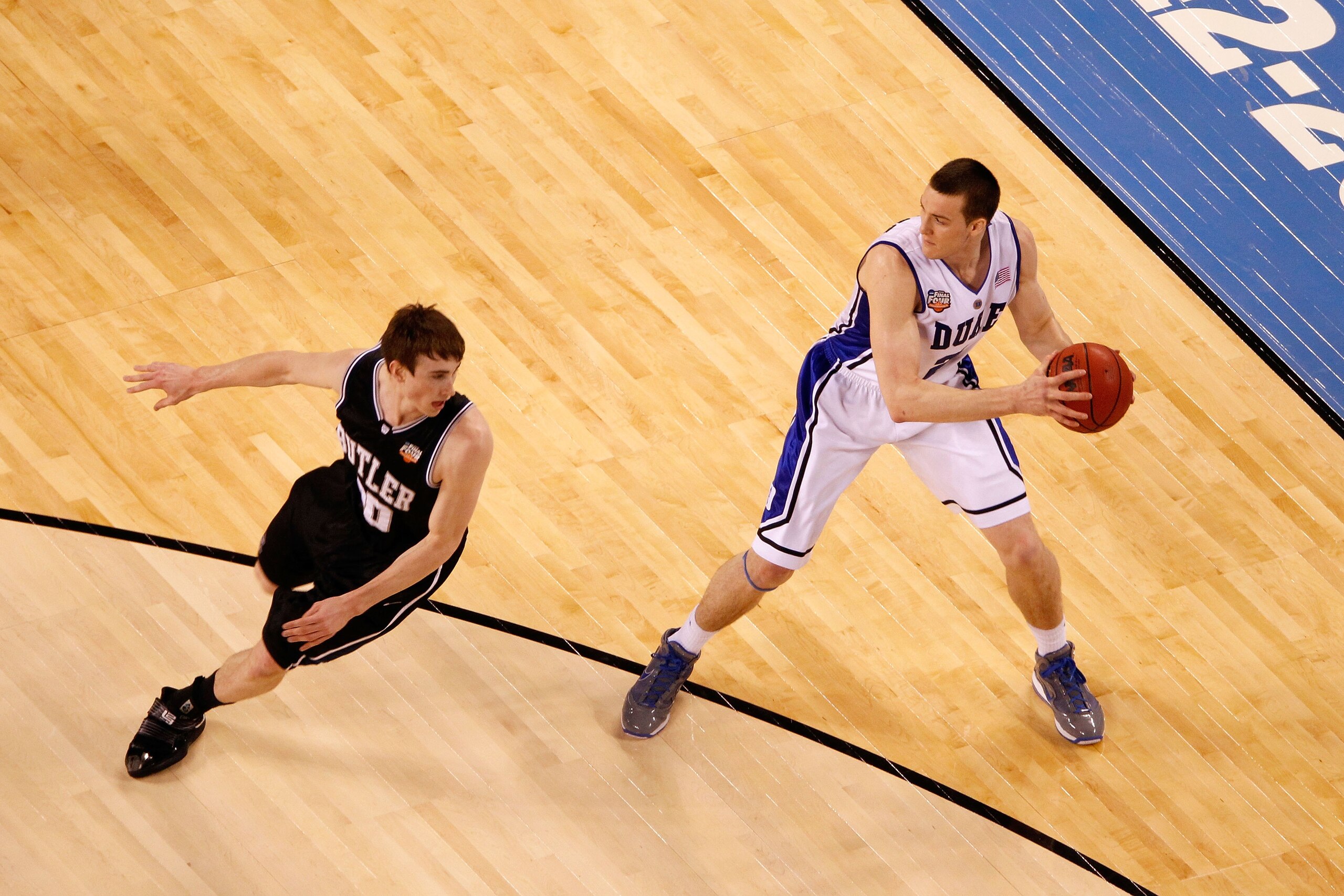 INDIANAPOLIS - APRIL 05:  Miles Plumlee #21 of the Duke Blue Devils looks to pass the ball against Gordon Hayward #20 of the Butler Bulldogs during the 2010 NCAA Division I Men's Basketball National Championship game at Lucas Oil Stadium on April 5, 2010
