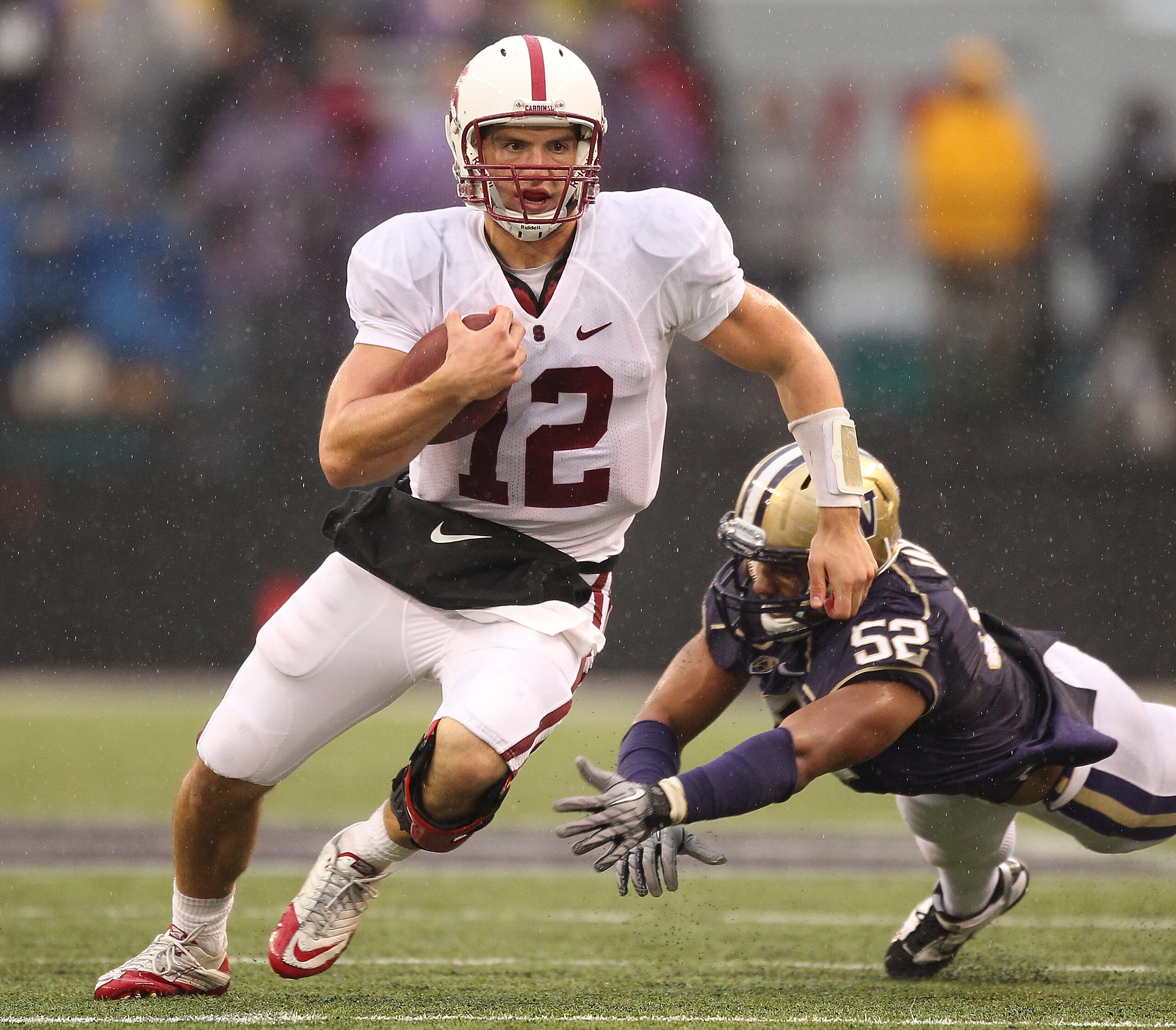 SEATTLE - OCTOBER 30:  Quarterback Andrew Luck #12 of the Stanford Cardinal rushes against Hau'oli Jamora #52 of the Washington Huskies on October 30, 2010 at Husky Stadium in Seattle, Washington. Stanford defeated Washington 41-0. (Photo by Otto Greule J
