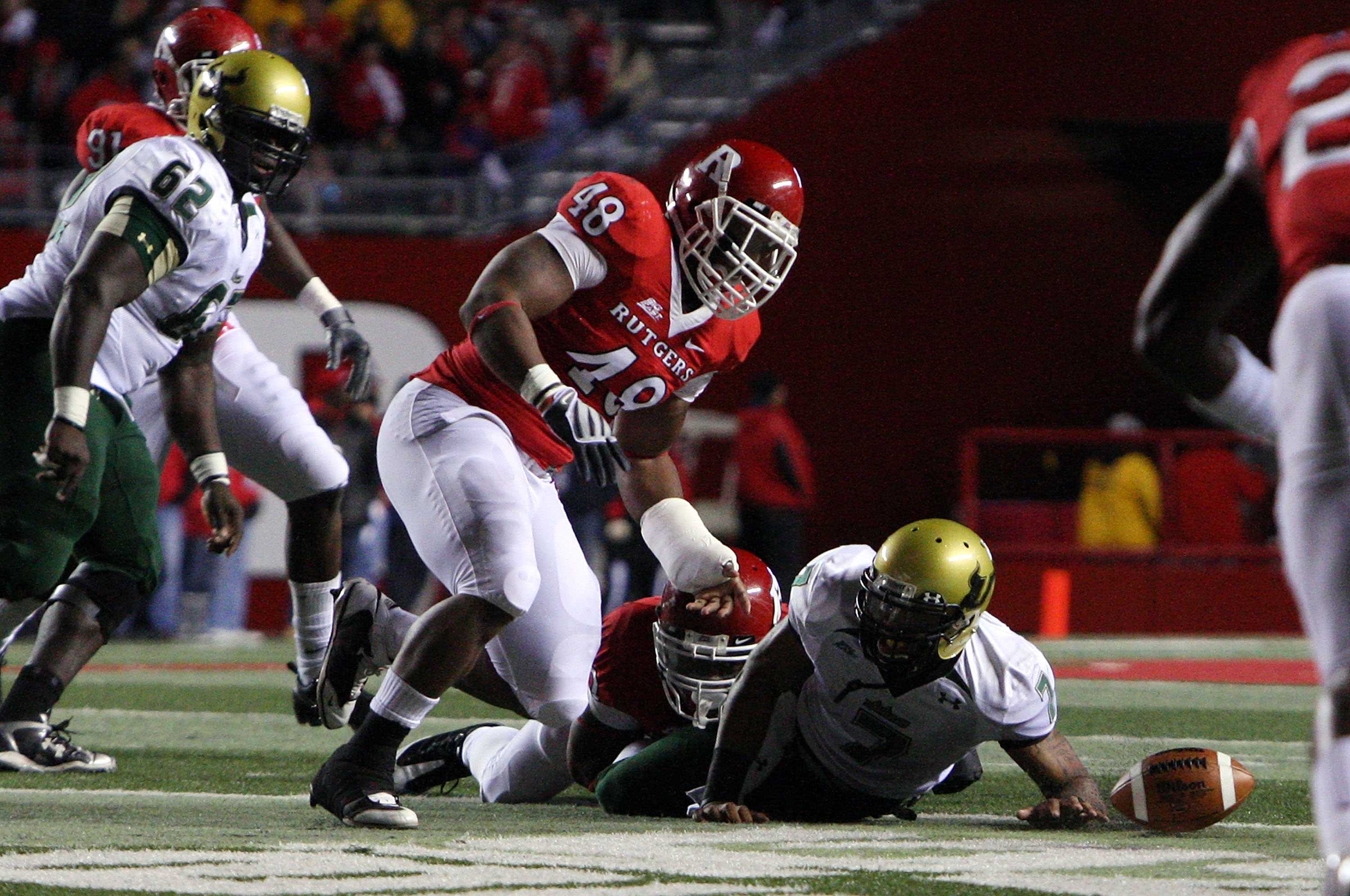 PISCATAWAY, NJ - NOVEMBER 12: Blair Bines #48 of the Rutgers Scarlet Knights recovers a fumble from B.J. Daniels #7 of the South Florida Bulls at Rutgers Stadium on November 12, 2009 in Piscataway, New Jersey. (Photo by Jim McIsaac/Getty Images)