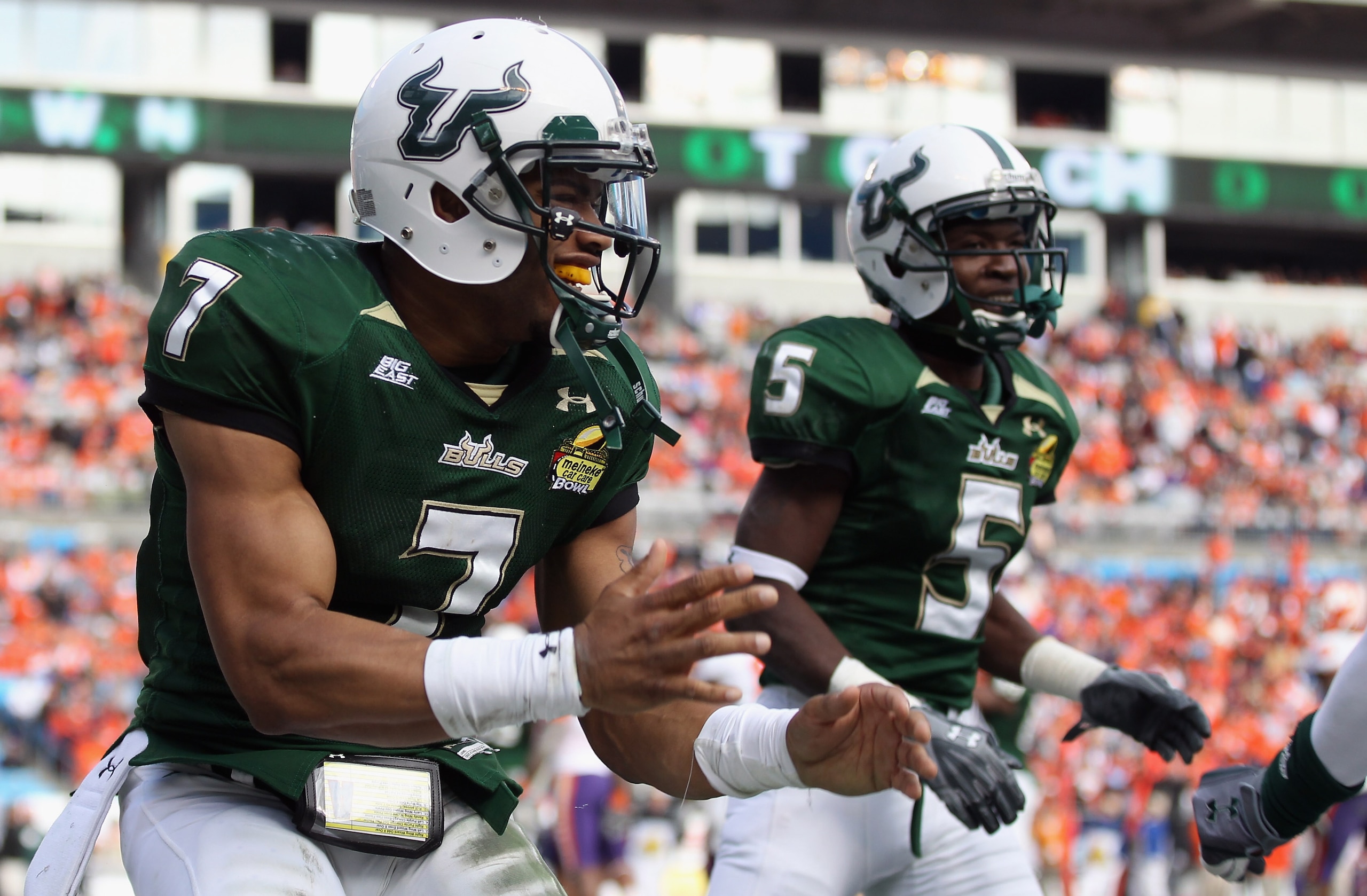 CHARLOTTE, NC - DECEMBER 31:  B.J. Daniels #7 of the USF Bulls celebrates after scoring a touchdown against the Clemson Tigers during their game at Bank of America Stadium on December 31, 2010 in Charlotte, North Carolina.  (Photo by Streeter Lecka/Getty