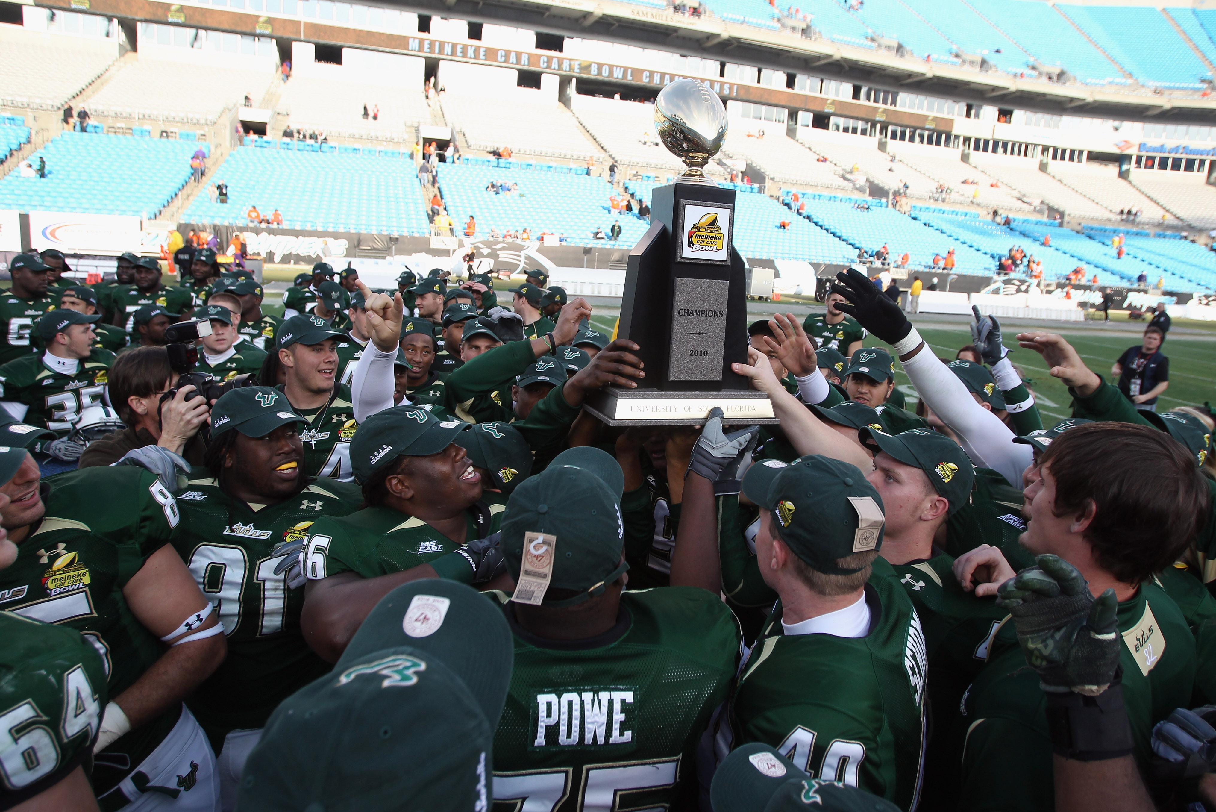 CHARLOTTE, NC - DECEMBER 31: The USF Bulls celebrate with the trophy after a 31-26 victory over the Clemson Tigers at Bank of America Stadium on December 31, 2010 in Charlotte, North Carolina. (Photo by Streeter Lecka/Getty Images)