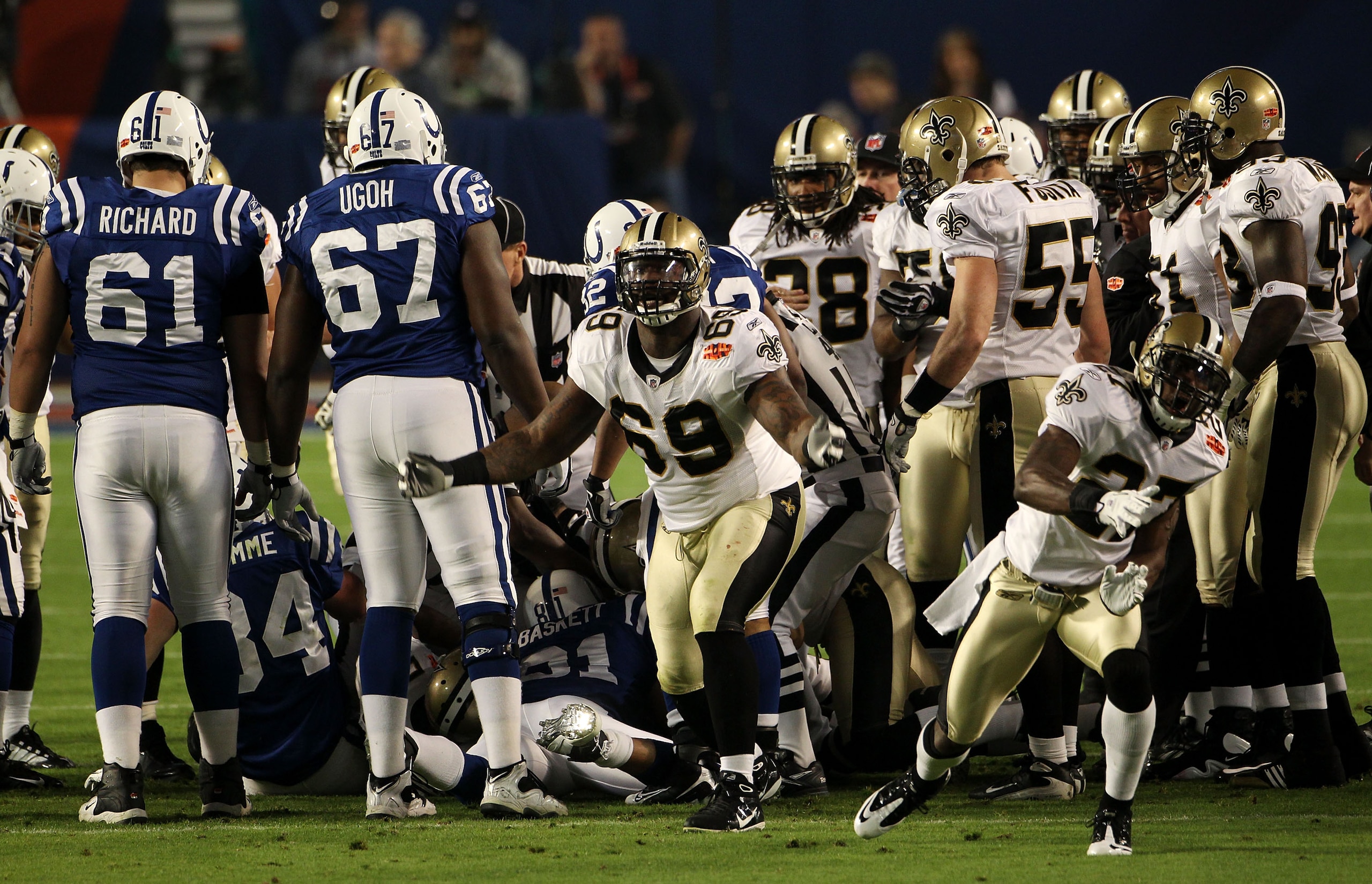 MIAMI GARDENS, FL - FEBRUARY 07:  Malcolm Jenkins #27 and Anthony Hargrove #69 of the New Orleans Saints reacts after a onside kick to start the second half  against the Indianapolis Colts during Super Bowl XLIV on February 7, 2010 at Sun Life Stadium in