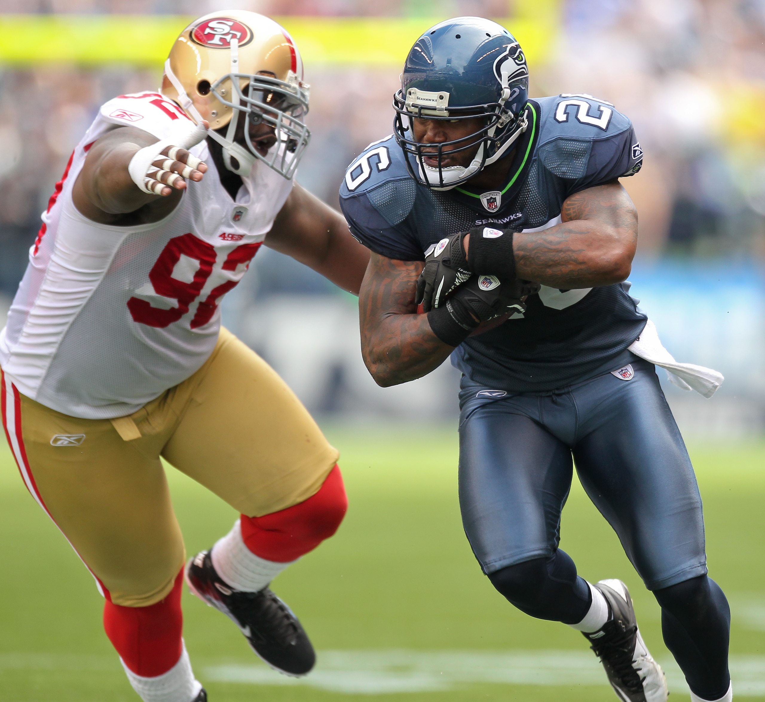 SEATTLE - SEPTEMBER 12:  Running back Michael Robinson #26 of the Seattle Seahawks rushes against Aubrayo Franklin #92 of the San Francisco 49ers during the NFL season opener at Qwest Field on September 12, 2010 in Seattle, Washington. (Photo by Otto Greu